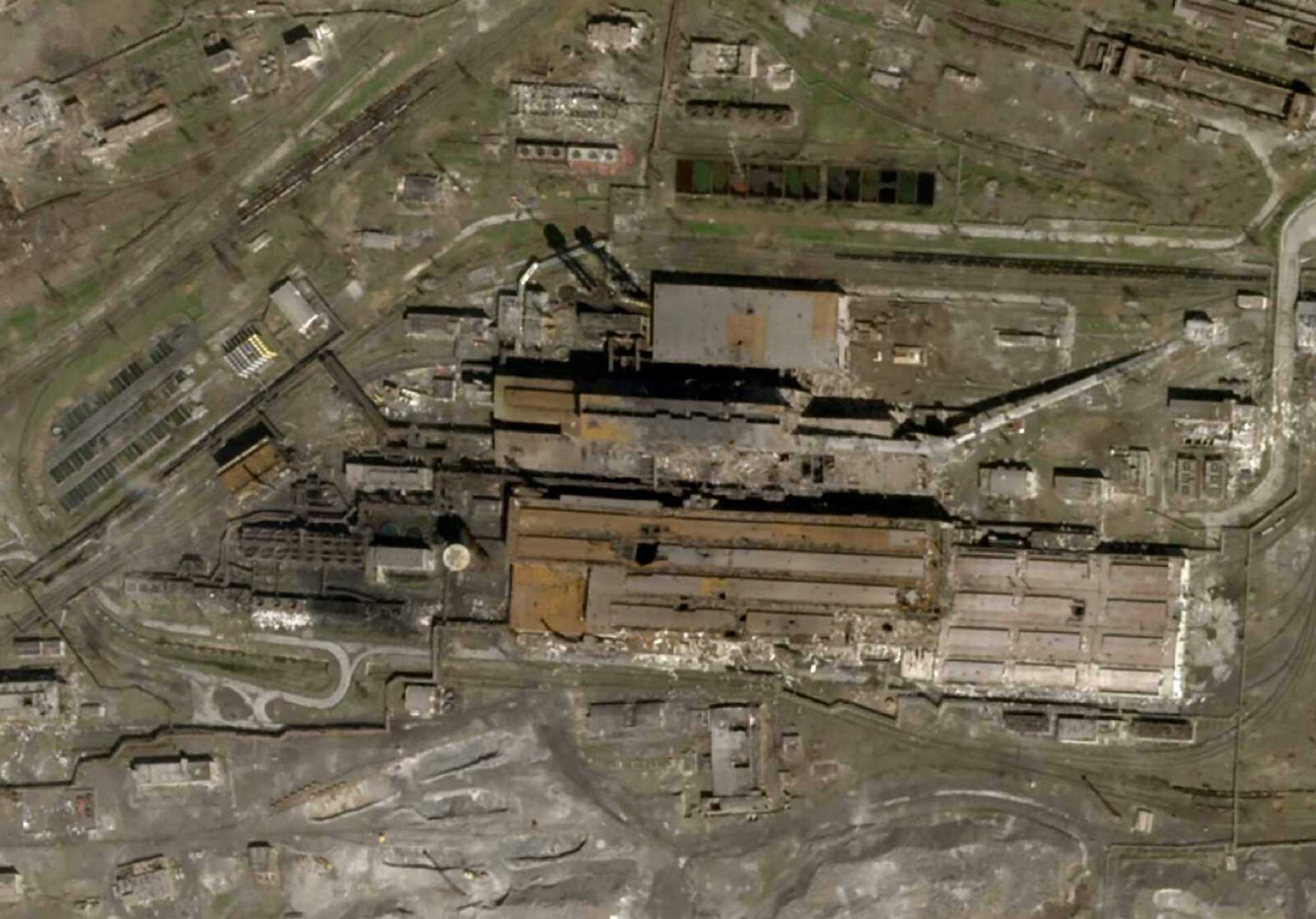 This satellite photo released by Planet Labs and taken Wednesday shows the Azovstal Steel Plant in Mariupol, Ukraine, with some large holes blasted in the roof.