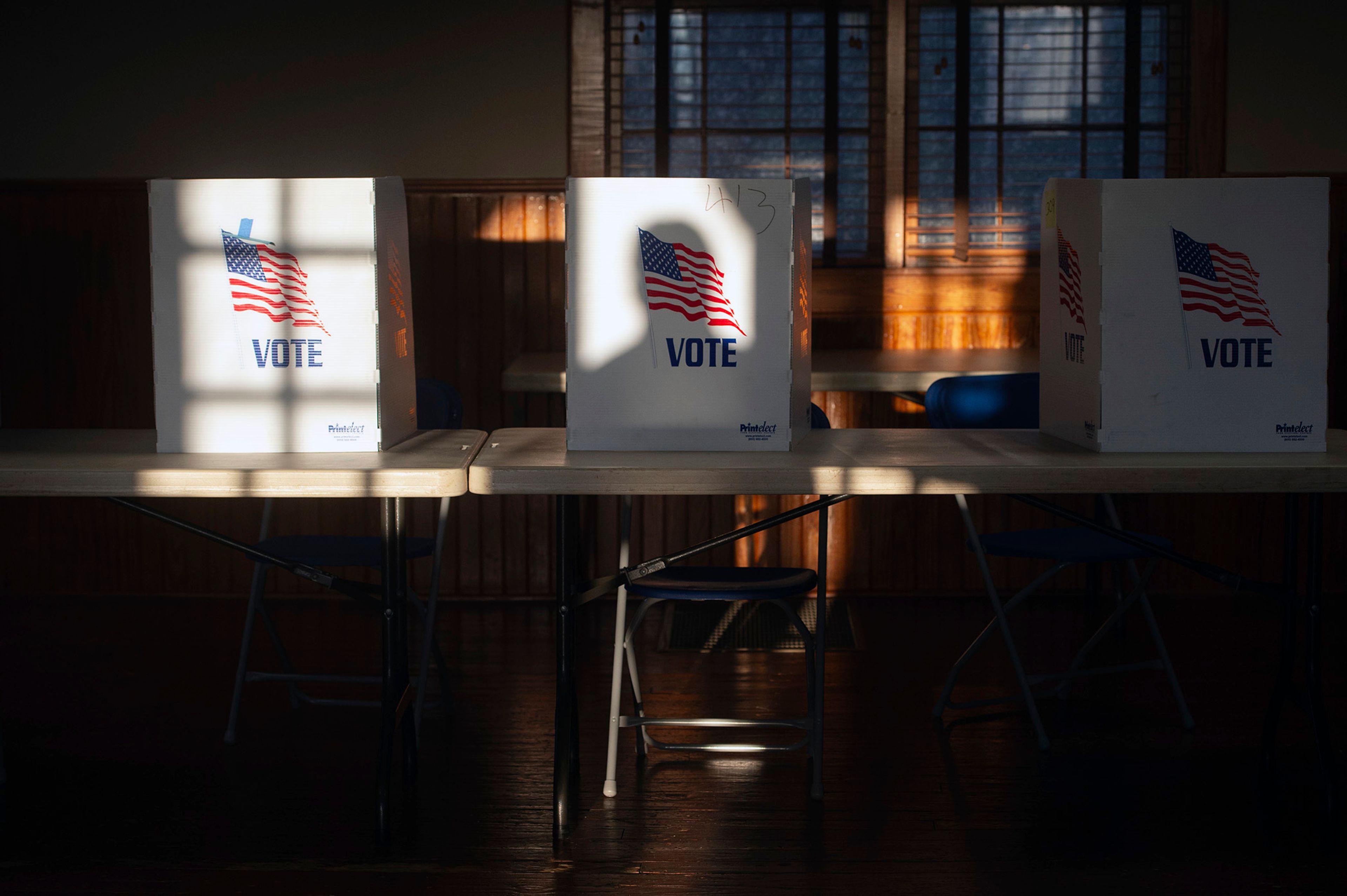 FILE - The shadow of a voter entering the precinct at St. Joseph Catholic Church in Gluckstadt, Miss., is cast on a privacy divider for people filling out ballots at Precinct 205 at during the primary election on March 12, 2024. (Barbara Gauntt/The Clarion-Ledger via AP)