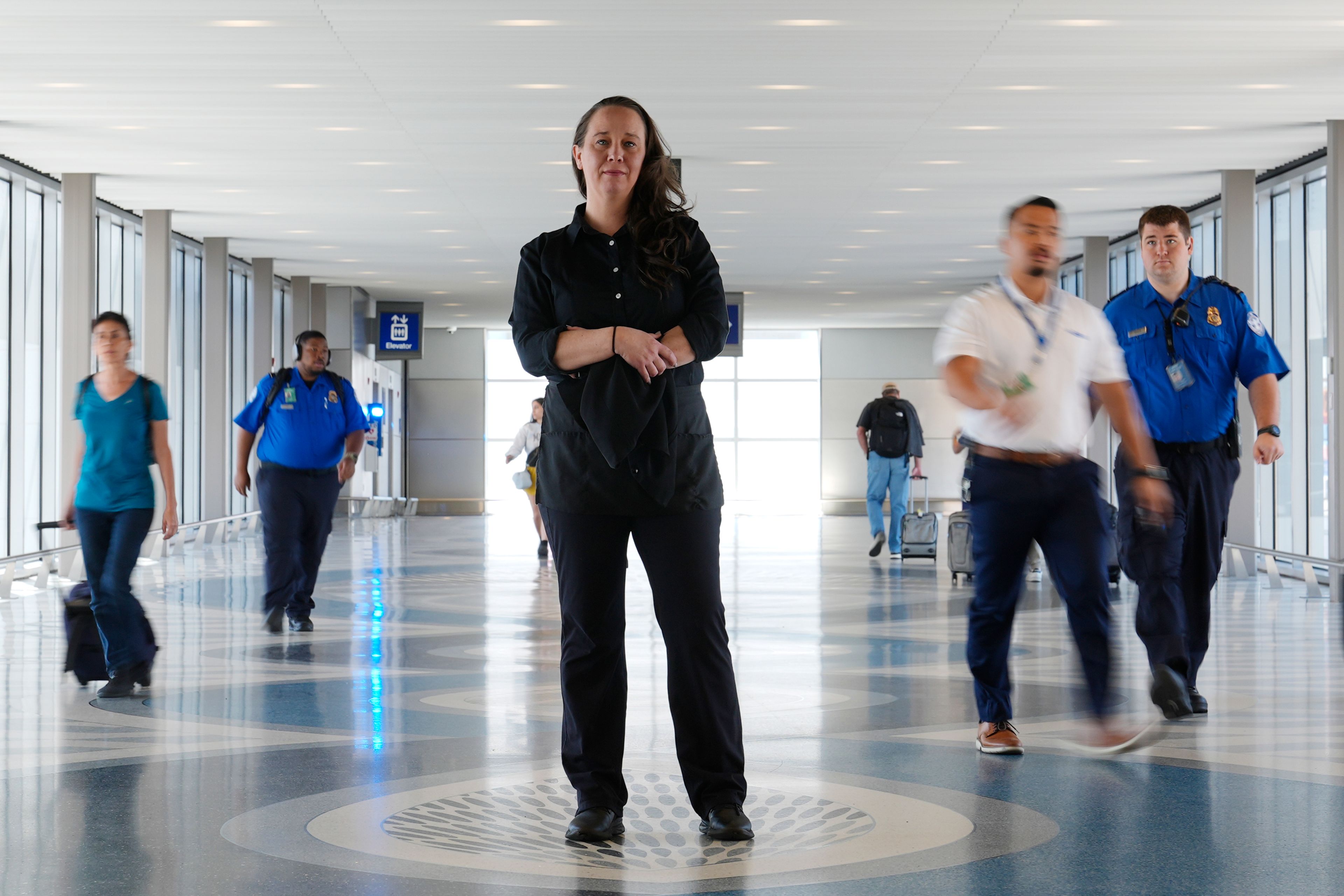 Lindsay Ruck, a server at Phoenix Sky Harbor International Airport restaurants, pauses in Terminal 3 as she works for minimum wage plus tips and is interested in the upcoming election and the Arizona Prop 138 on minimum wage vote Thursday, Oct. 3, 2024, in Phoenix. (AP Photo/Ross D. Franklin)