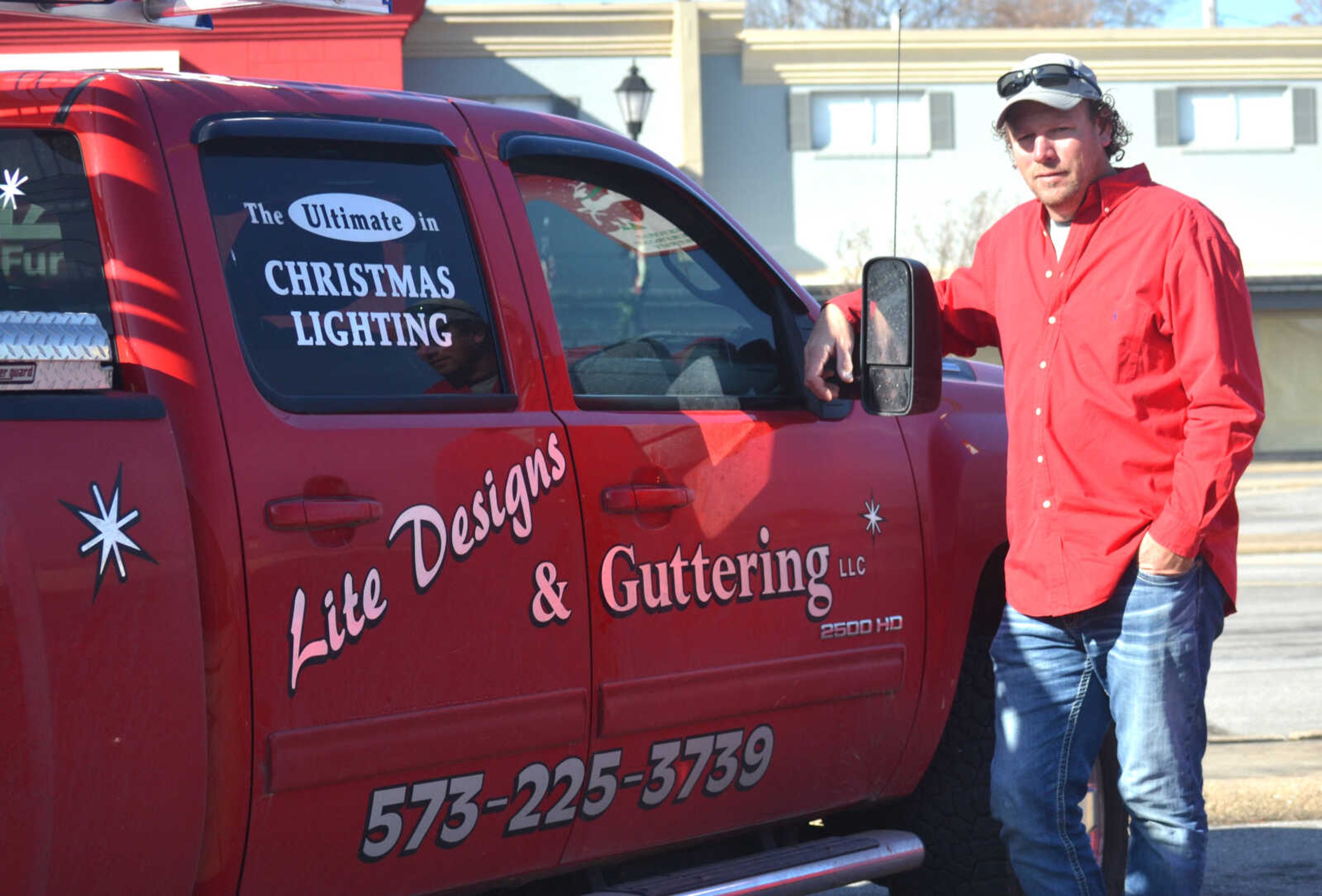 C.B. Forck poses for a photo with one of his Forck’s Lite Designs & Guttering company trucks.