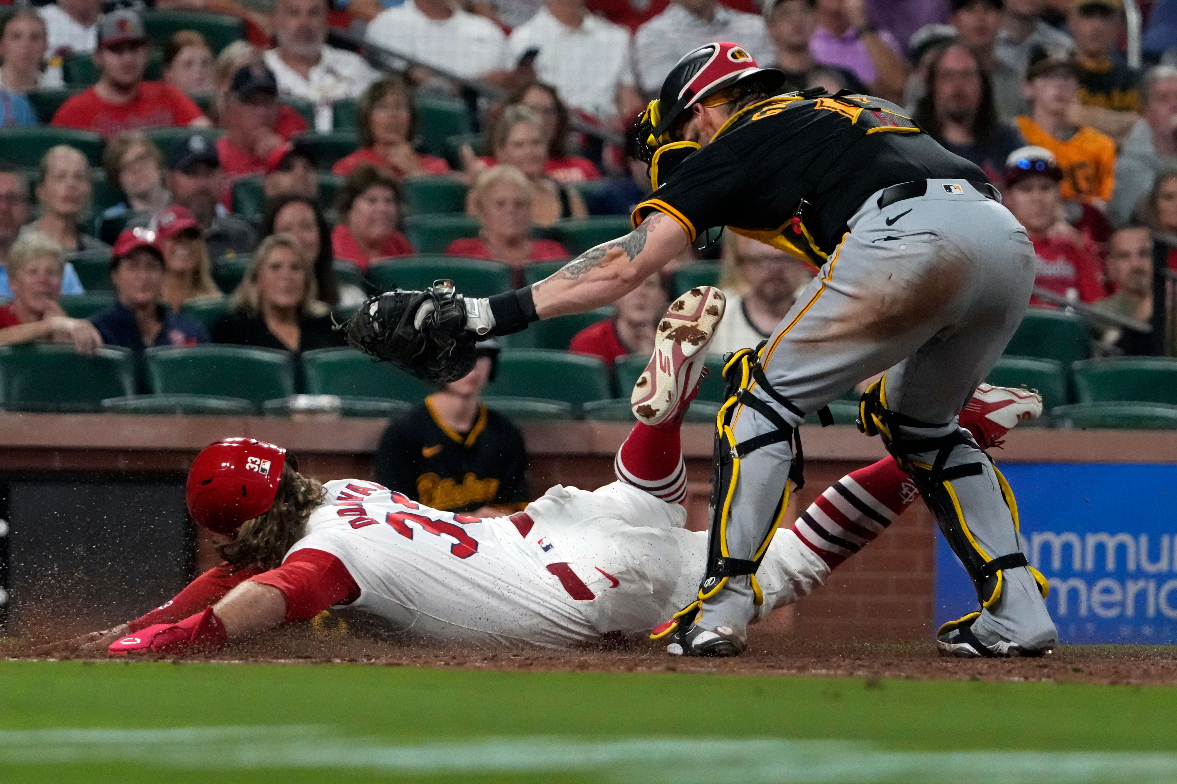 St. Louis Cardinals' Brendan Donovan, left, is tagged out by Pittsburgh Pirates catcher Yasmani Grandal during the eighth inning of a baseball game Monday, Sept. 16, 2024, in St. Louis. (AP Photo/Jeff Roberson)