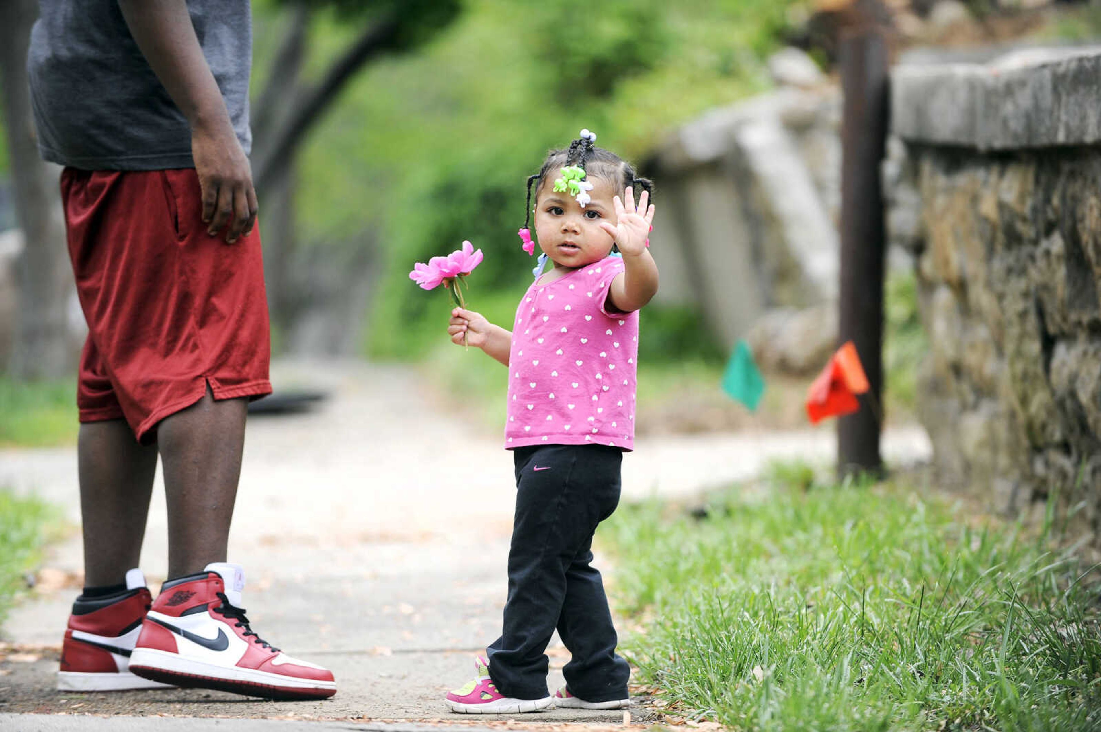 LAURA SIMON ~ lsimon@semissourian.com

Karmen Cooper, who will be 2 in July, waves while holding a freshly picked peony during her post-nap walk down Lorimier Street in Cape Girardeau Wednesday afternoon, April 28, 2016.