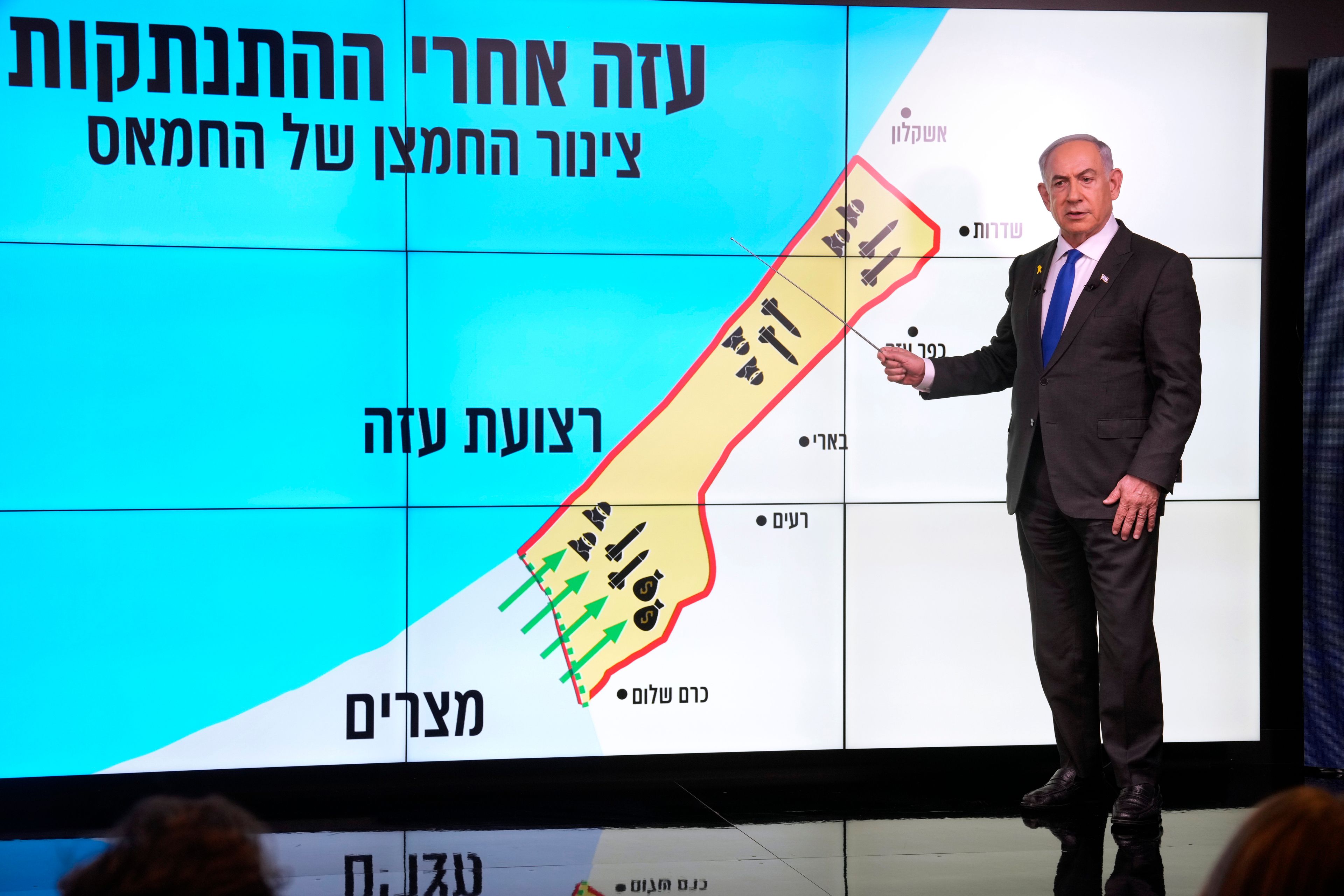 Israeli Prime Minister Benjamin Netanyahu stands before a map of the Gaza Strip, telling viewers how Hamas has imported arms into the territory since Israel's withdrawal in 2005, during a news conference in Jerusalem, Monday, Sept. 2, 2024. The Hebrew on the screen reads, "Gaza after the disengagement, oxygen pipe of Hamas". (AP Photo/Ohad Zwigenberg, Pool)