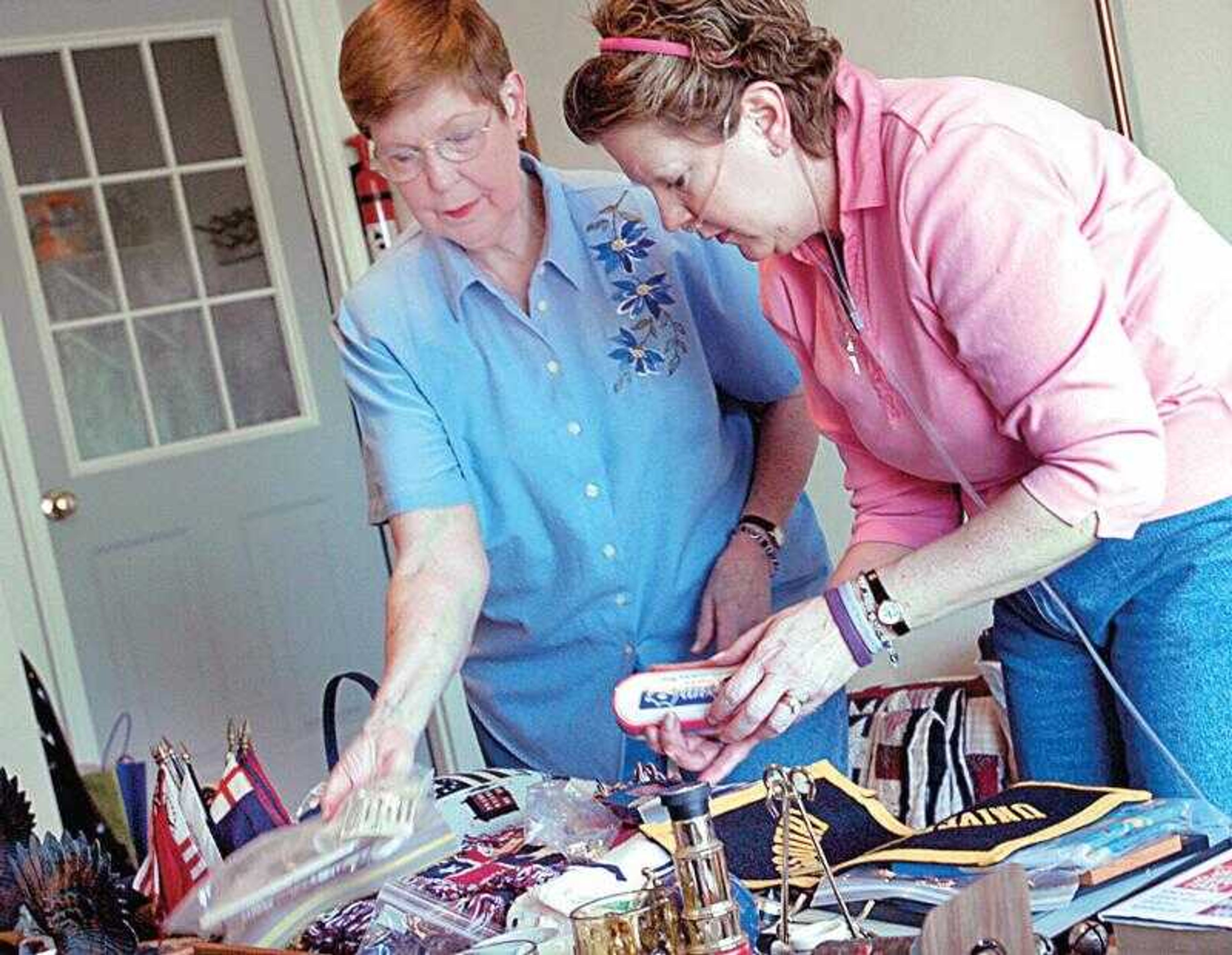 Betty Deardorff, left of Jackson, and her daughter Marta Dreyer Hamlin of Chesterfield, Mo., worked together on organizing Deardorff's moving sale. Hamlin has a rare long disease and her mother is moving to Chesterfield to be with her daughter during her illness.