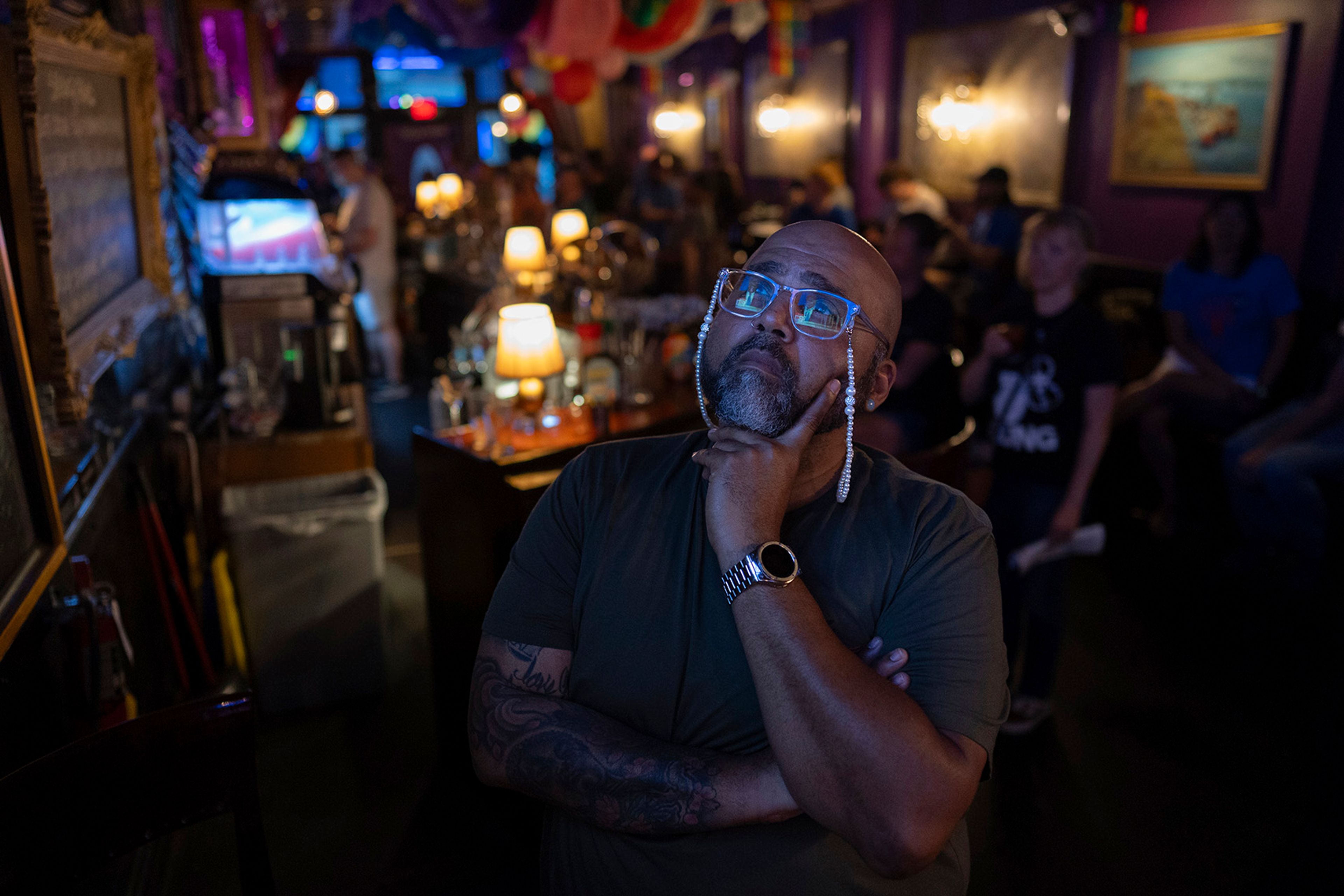 Jocardo Ralston, 47, from Pennsylvania, looks up to a television to watch the presidential debate between President Joe Biden and Republican presidential candidate former President Donald Trump at Tillie's Lounge on Thursday, June 27, 2024, in Cincinnati. 