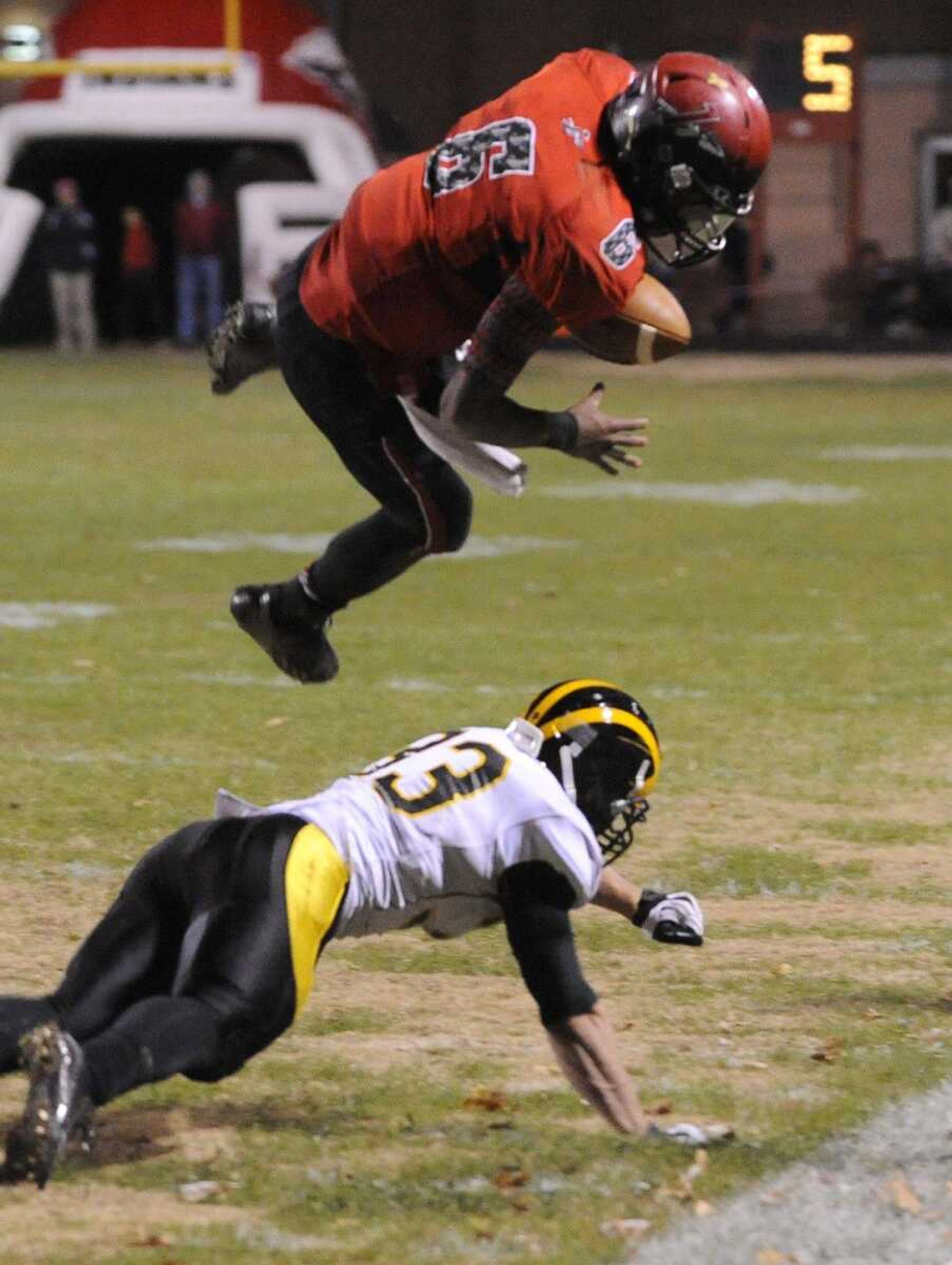 Jackson quarterback Dante Vandeven takes to the air over Vianney's Nick Hebenstreit during the fourth quarter of the Class 5 District 1 title game Friday, Nov. 7, 2014 in Jackson. (Fred Lynch)