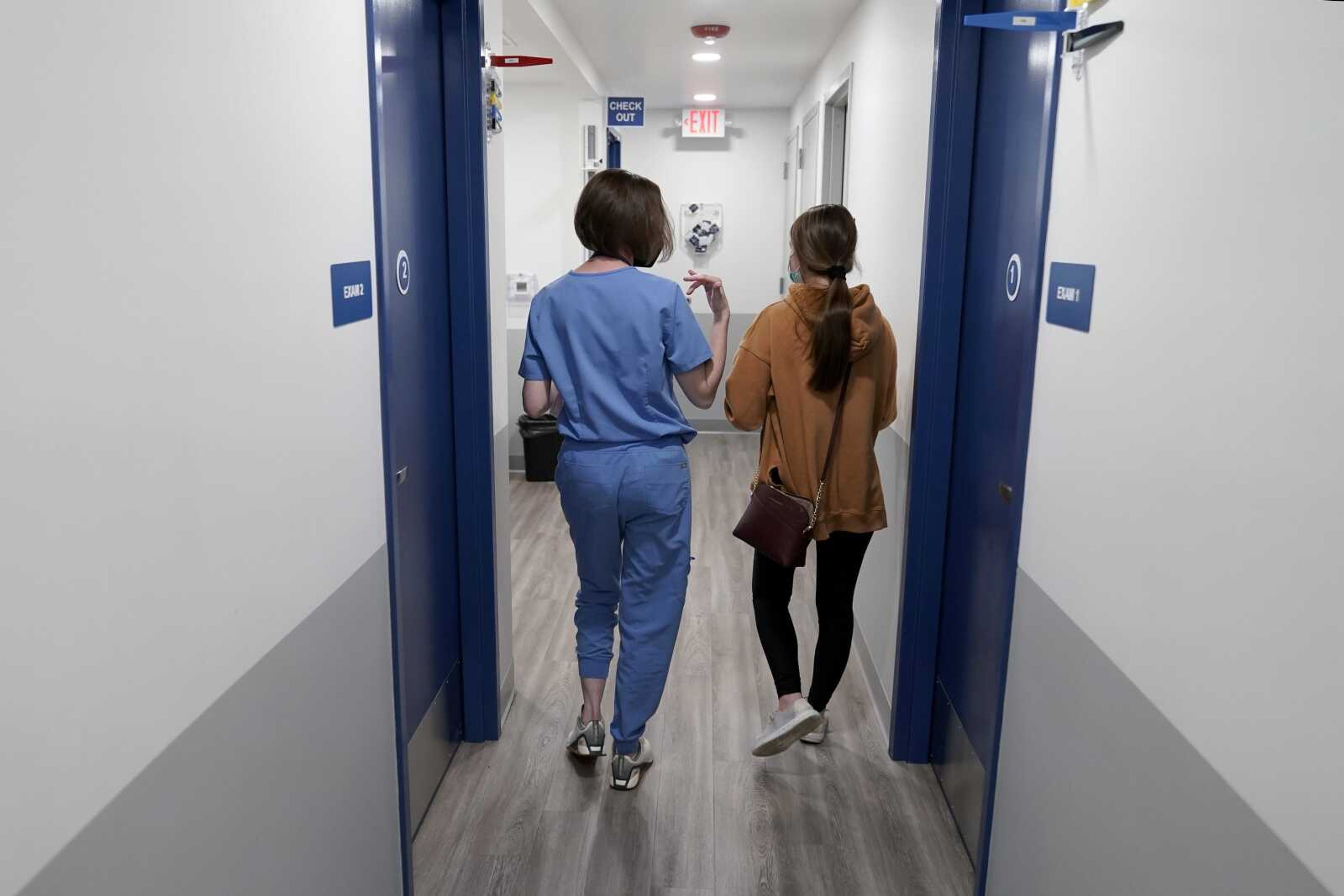 Dr. Elizabeth Brett Daily, left, walks with patient Haley Ruark after providing a medical abortion at a Planned Parenthood clinic Wednesday, Oct. 12, in Kansas City, Kansas.