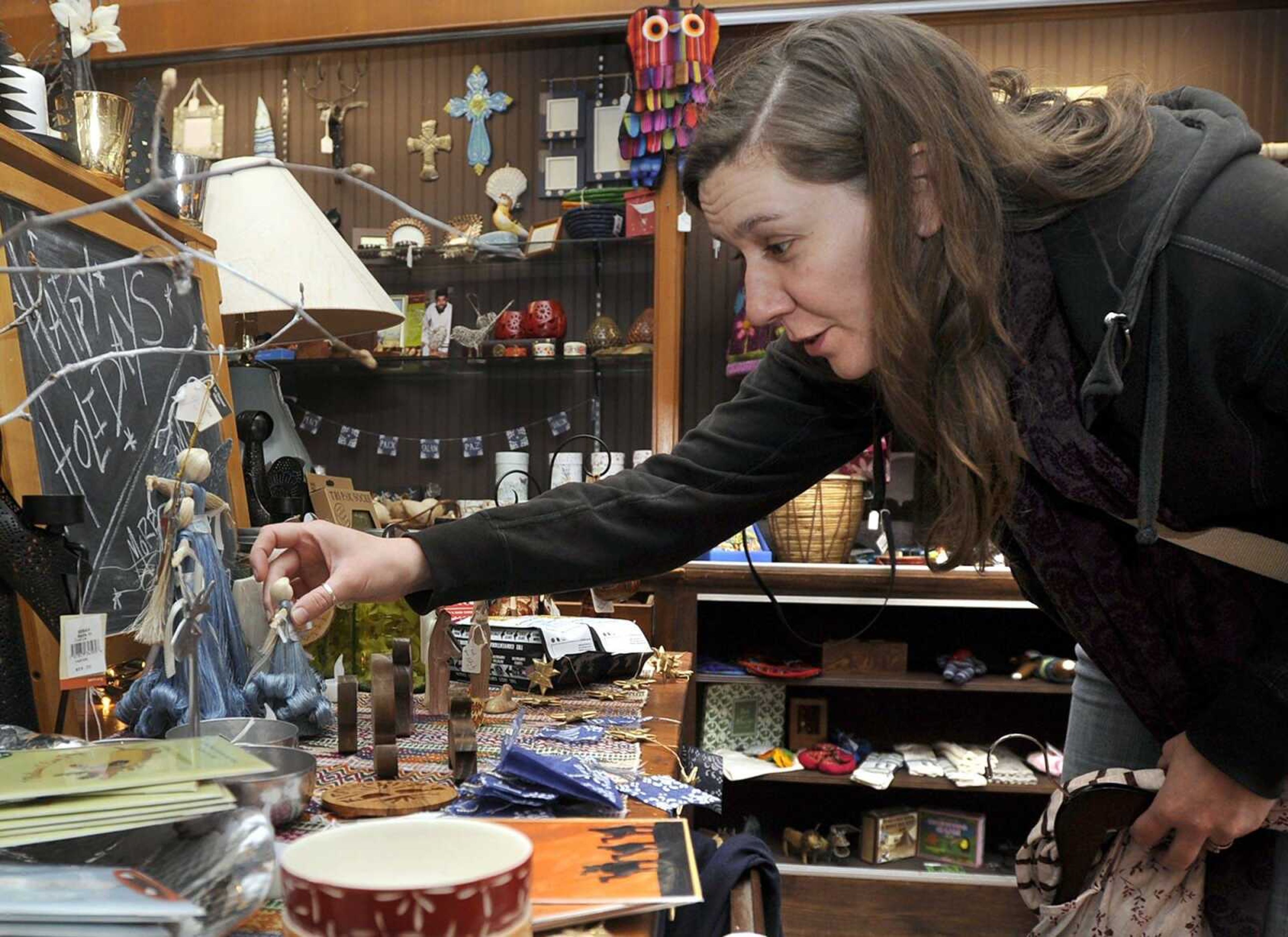 Joanna Pincosy checks out a few items while shopping at Lattitudes during Small Business Saturday in downtown Cape Girardeau. More photos are in a gallery at semissourian.com. (Fred Lynch)