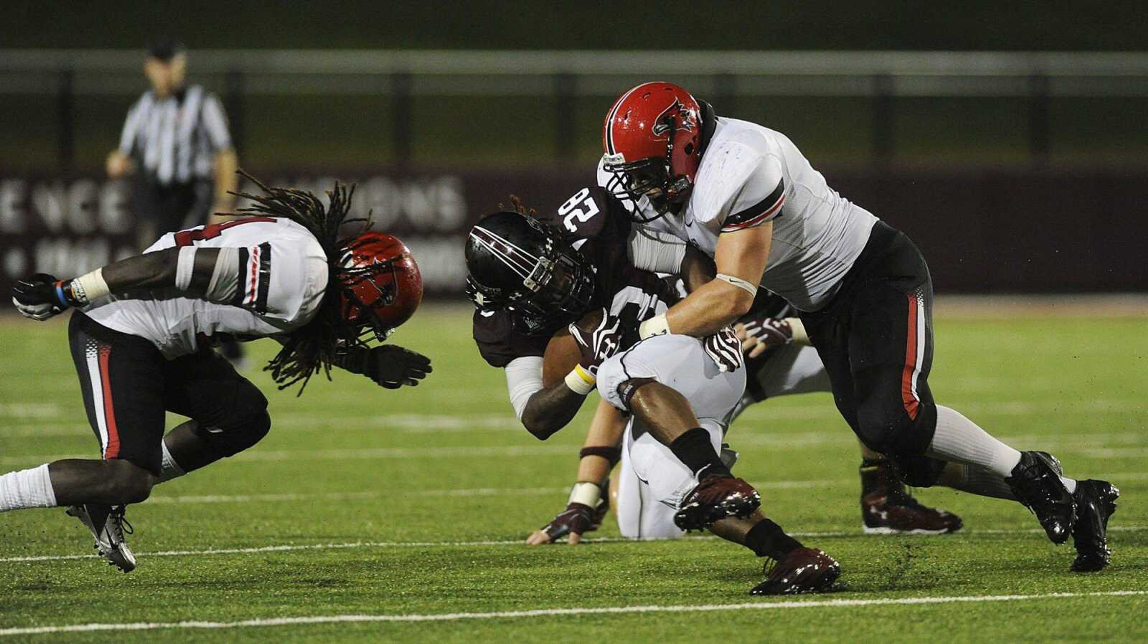 Southeast Missouri State linebacker Blake Peiffer, right, and defensive back Cantrell Andrews tackle Southern Illinois running back Steve Strother on Saturday. (ADAM VOGLER)