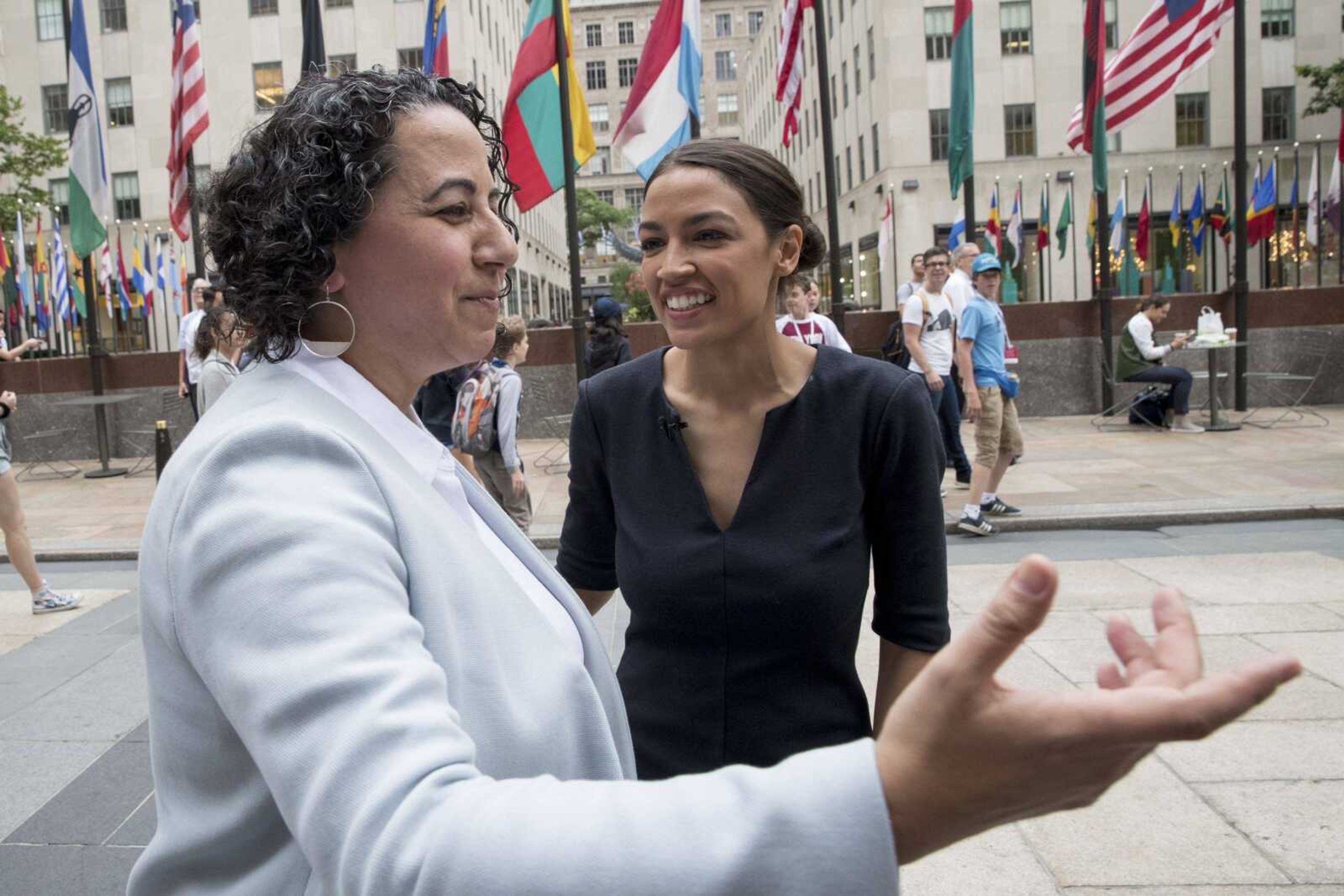 Alexandria Ocasio-Cortez, right, speaks Wednesday to Maya M. Berry, executive director of the Arab American Institute in New York.