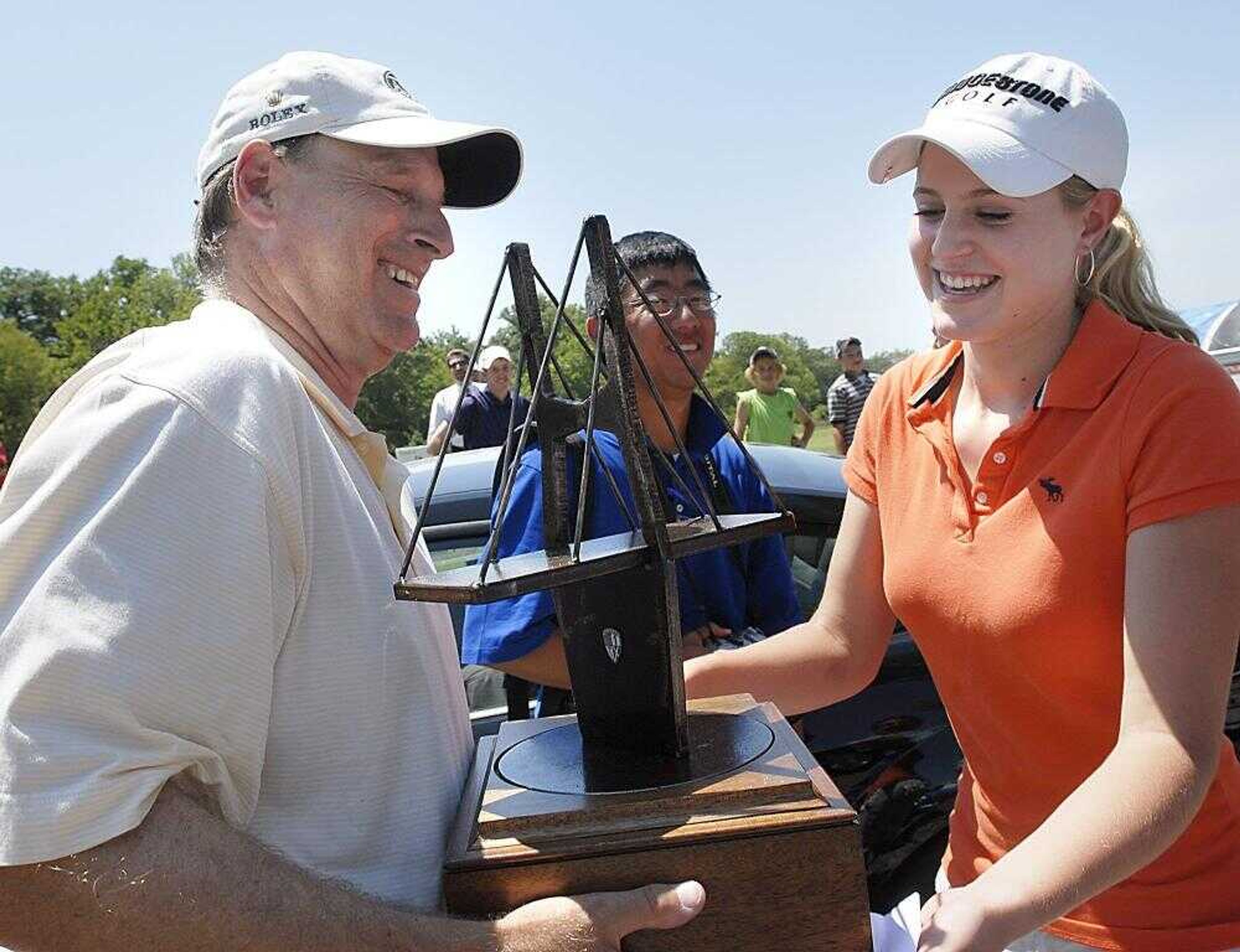 Katie Sylvan passed her AJGA Dalhousie Junior Championship winner's trophy to her father Paul on Thursday. The trophy weighed about 15 pounds. (Kit Doyle)