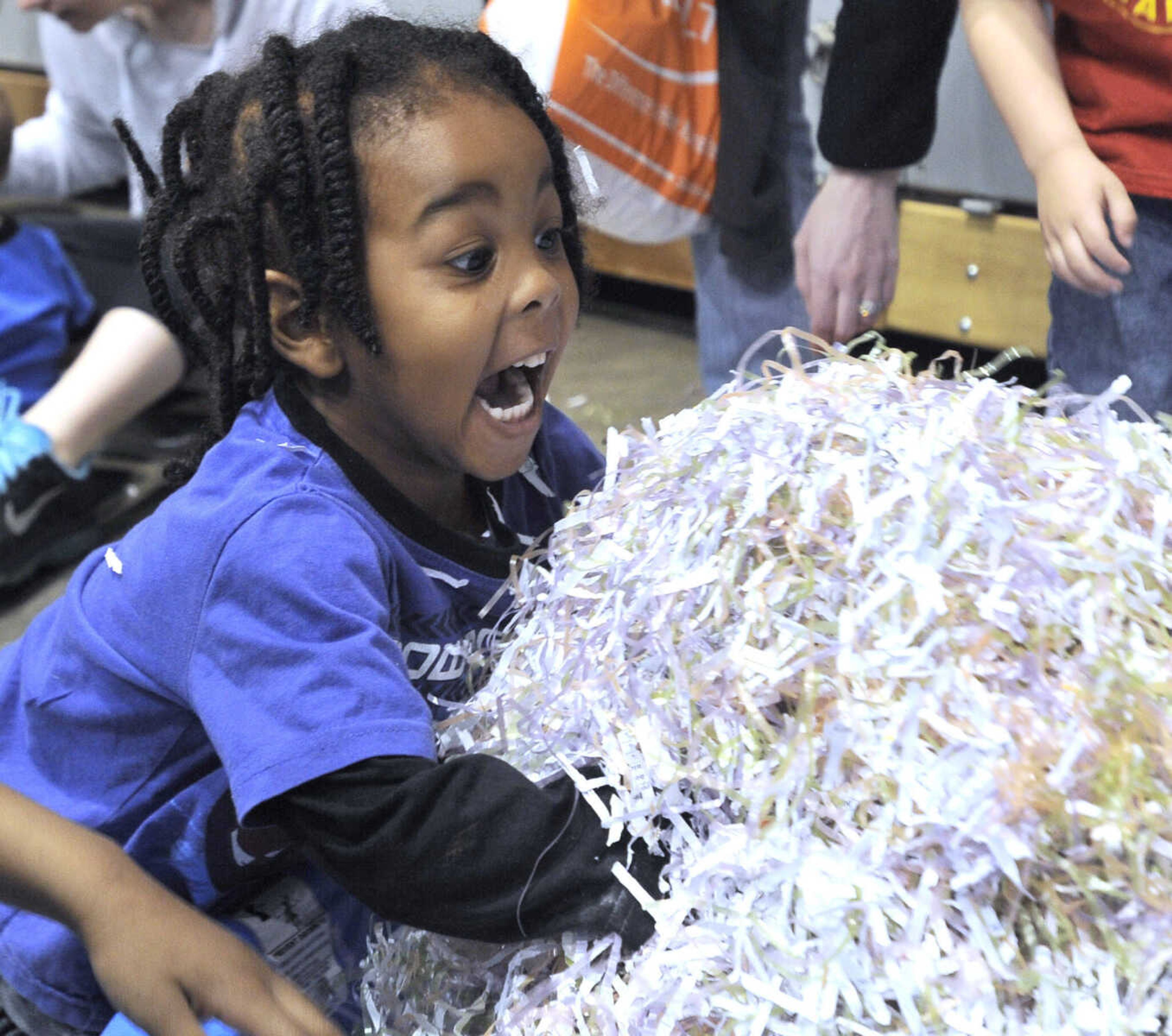 Xavier Waddy of Cape Girardeau has fun with shredded paper at the Messy Morning event Saturday, April 25, 2015 at the Show Me Center.