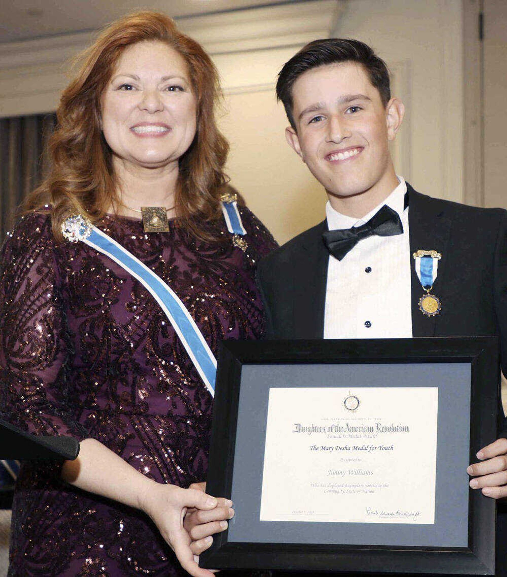 Renee Pace, MSSDAR State Regent awards Jimmy Williams with the Mary Desha Medal for Youth Award.