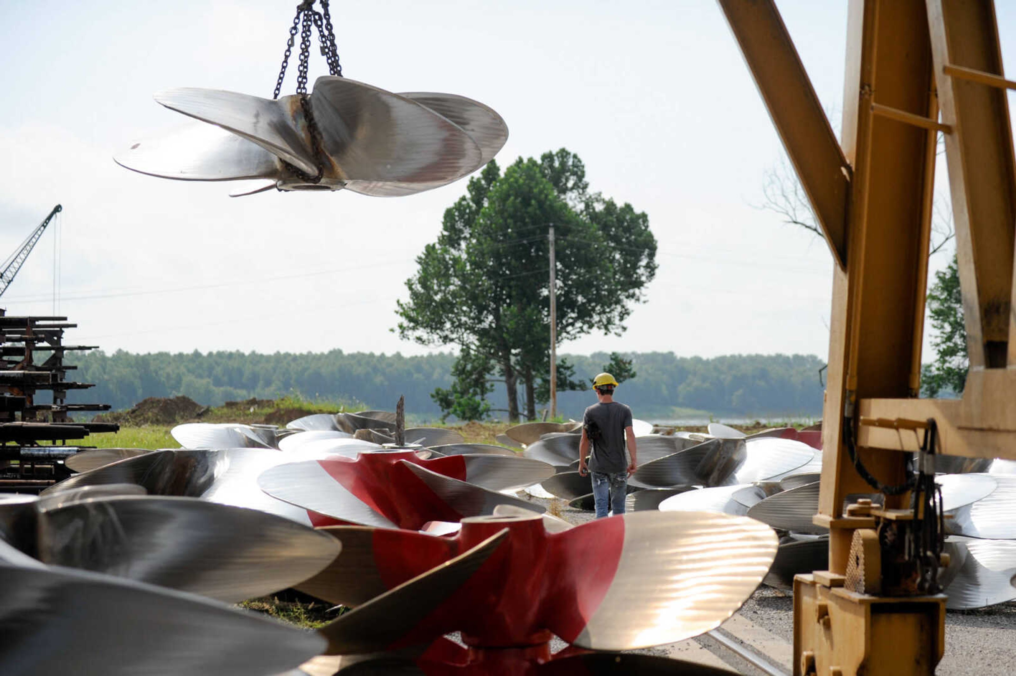 GLENN LANDBERG ~ glandberg@semissourian.com

Kyler Hale walks among a group of propellers outside the repair shop at Missouri Dry Dock and Repair Co. in Cape Girardeau Wednesday, July 28, 2016.