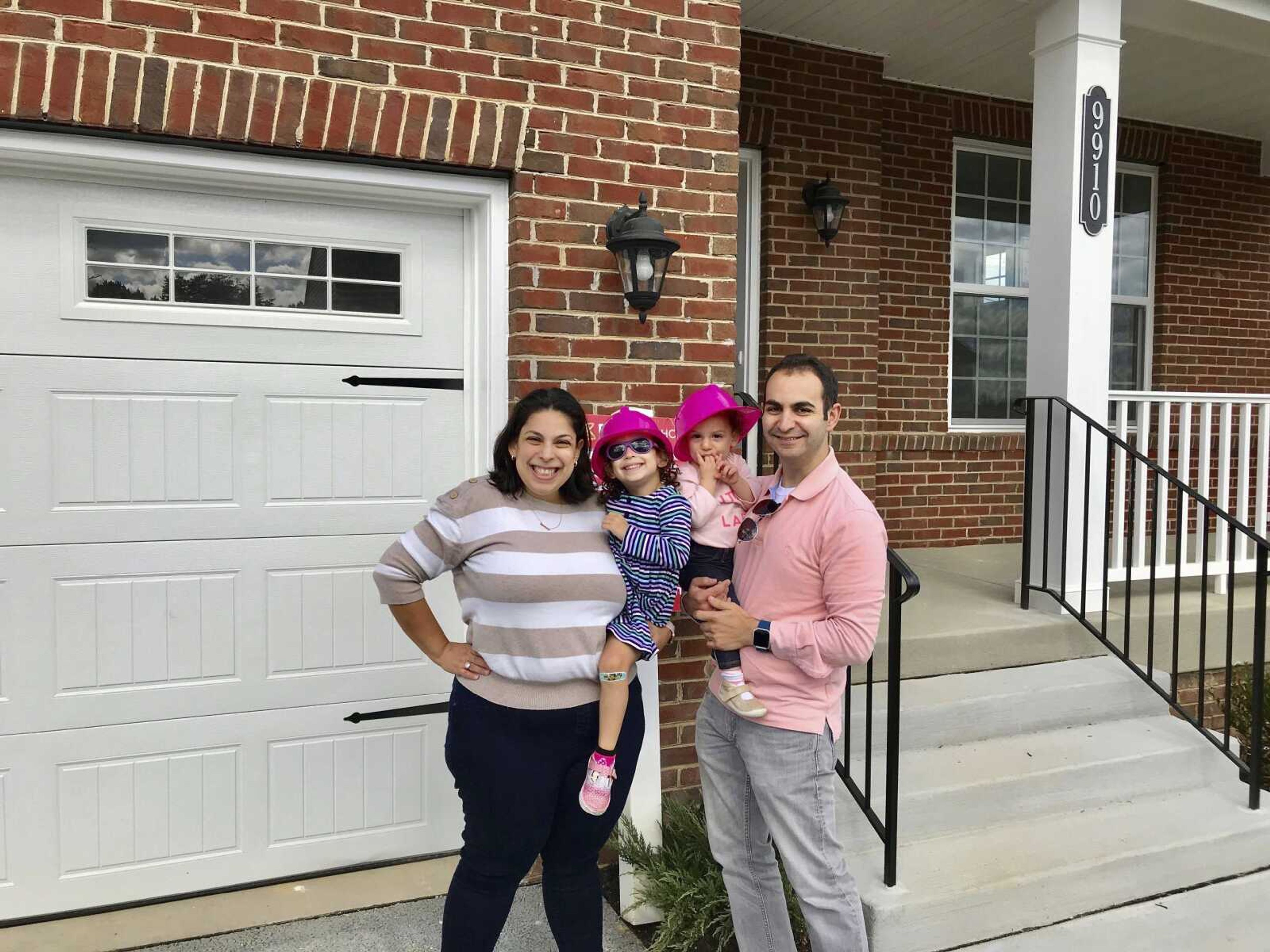 This undated photo provided by Nerdwallet shows from left, Allison, Abigail, Isabel and Matt Weil in front of a their new home in Laurel, Maryland. The Weils have twice used mortgage loans from Matt's parents to buy a home.