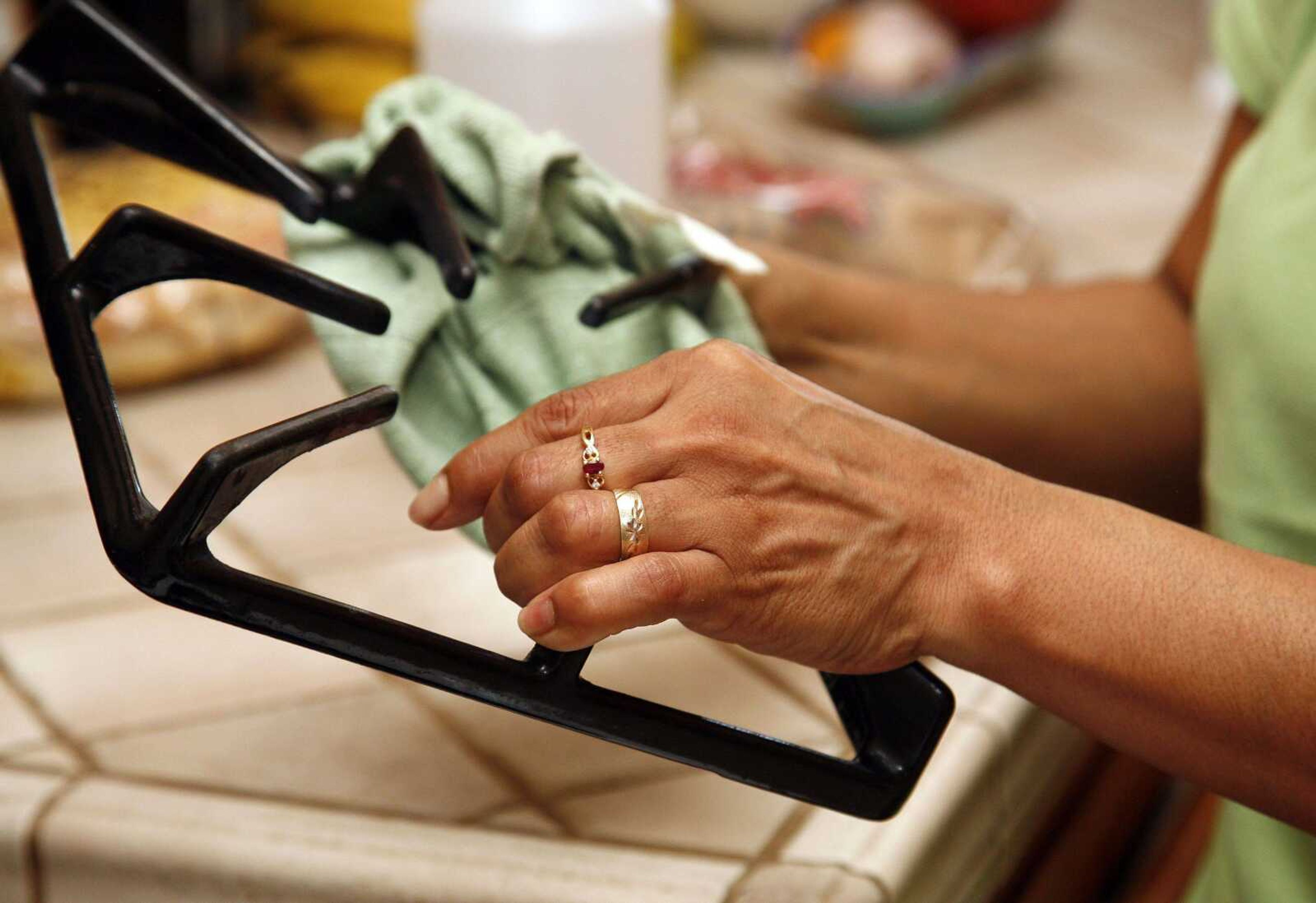 In this March 10, 2011 photo Merry Maids employee Esther Jimenez cleans the stove of a home in Burbank, Calif. Spring cleaning is easier and more efficient if you use the right tools, techniques and products. (AP Photo/Jason Redmond)