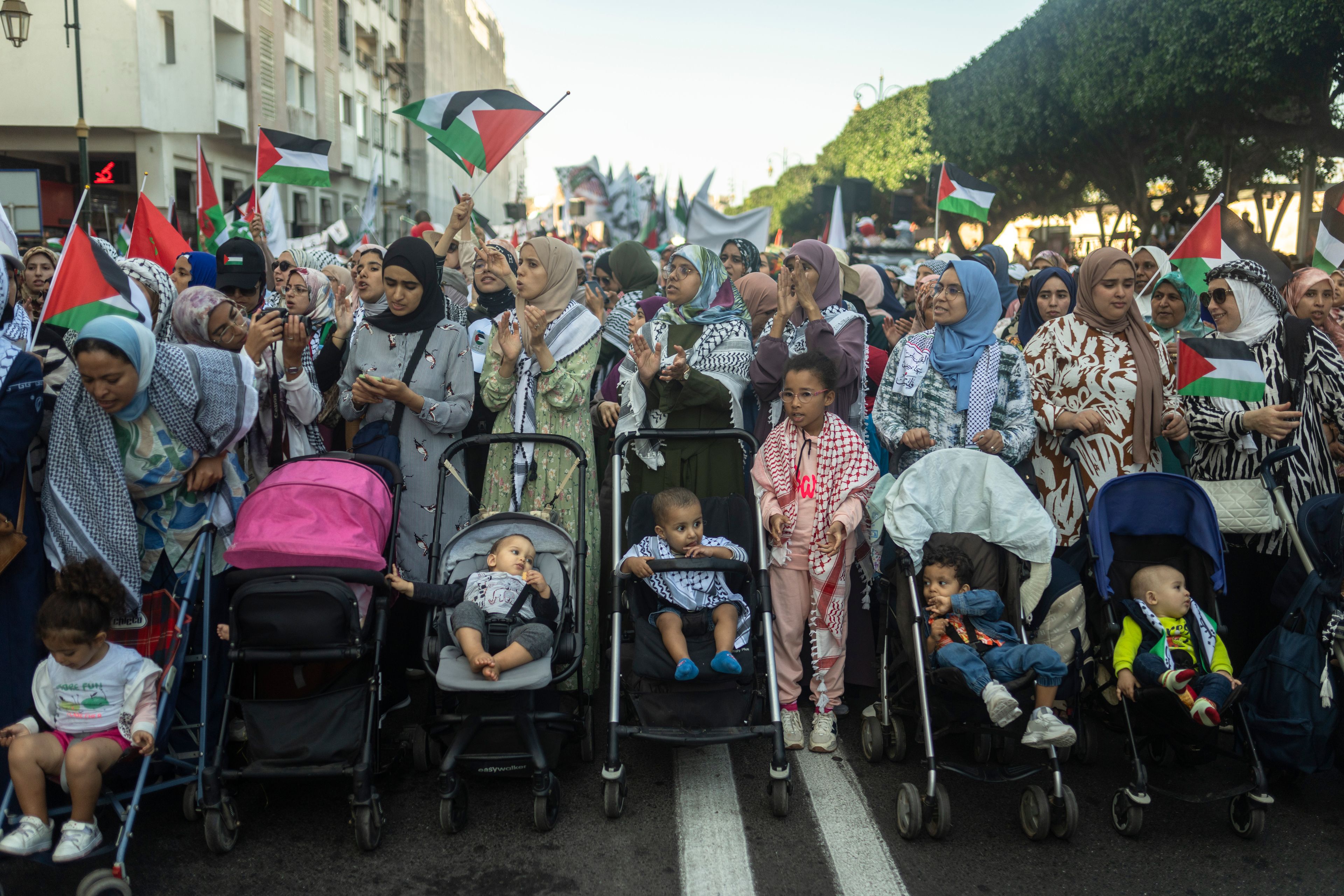 Moroccan women wave flags and chant slogans in support of Gaza and Lebanon during a protest in Rabat, Morocco, Sunday, Oct. 6, 2024 (AP Photo/Mosa'ab Elshamy)