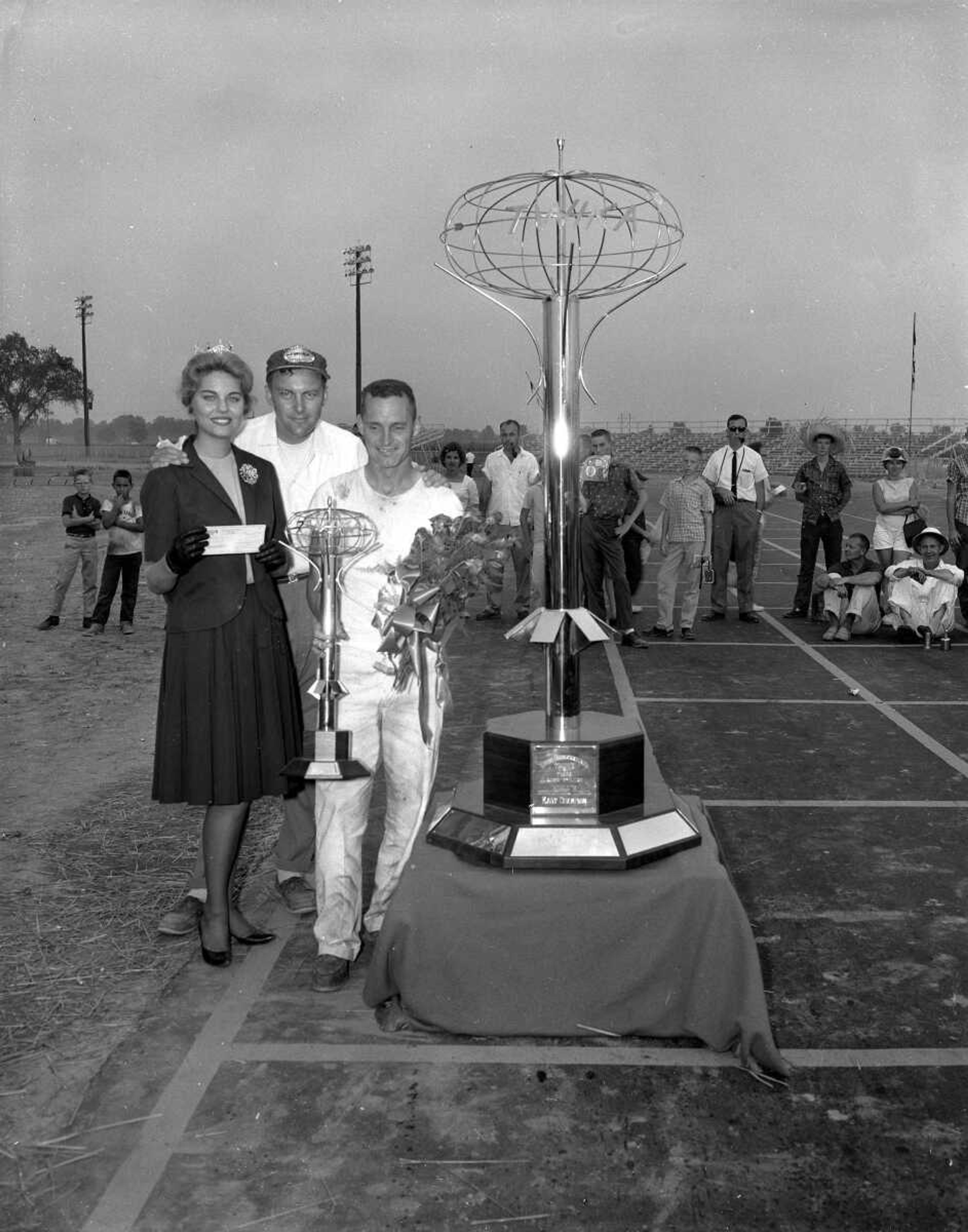 Published Monday, Aug. 28, 1961
Andy Watson, right, winner of the World's Championship Overall Go-Kart Race Sunday, is being handed the $1000 prize and Eddie Rickenbacher Trophy from Miss Missouri of 1961, Miss Sarah Kay Burns of Caruthersville, while TWIKA President Sig Petchul, in the middle, looks on. (Missourian archives photo by G.D. "Frony" Fronabarger)