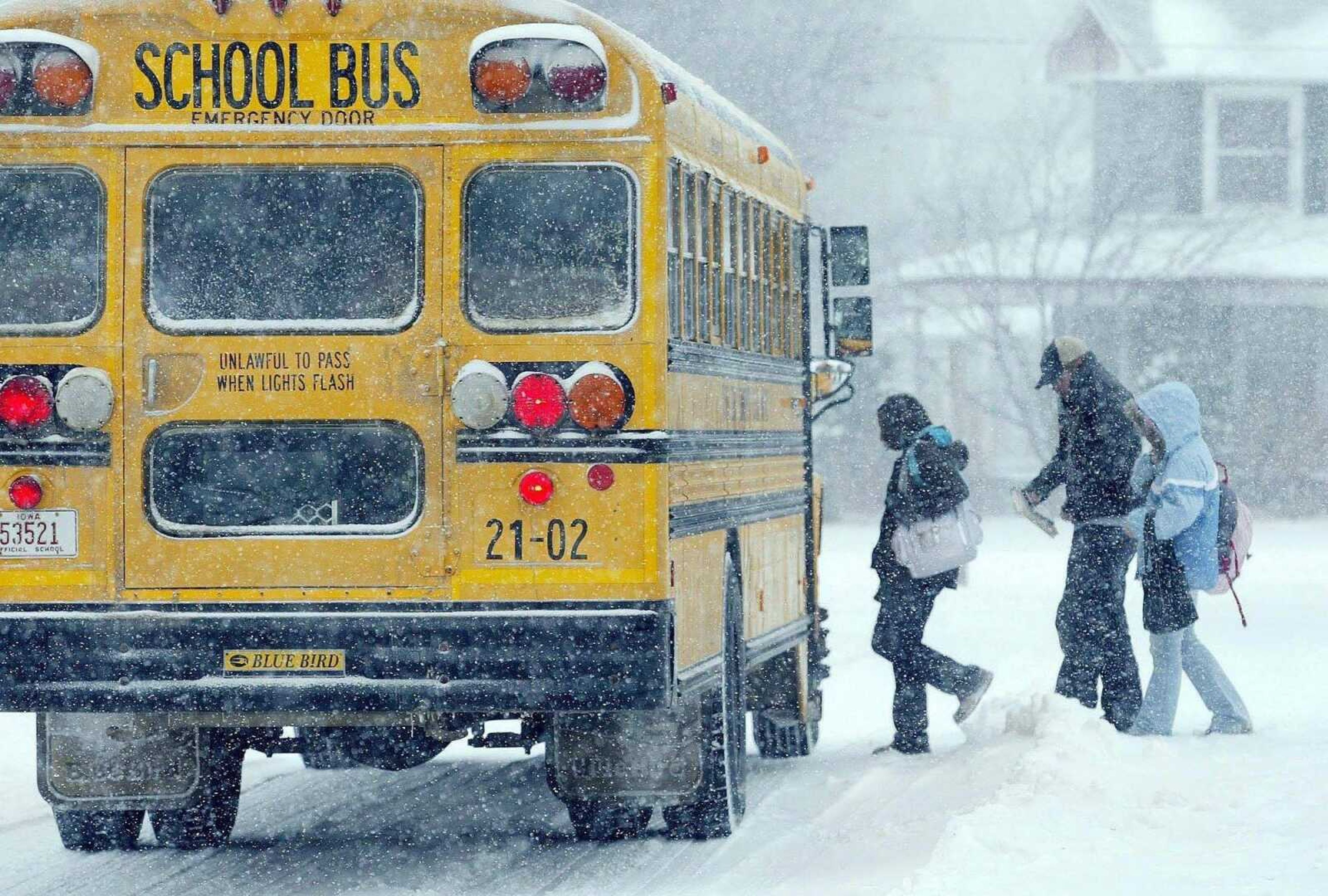 Harry Baumert ~ Des Moines Register<br>Students get on a school bus after their school dismissed early because of severe weather Monday in Stanwood, Iowa. The state was one of several caught by a blast of wintry weather.