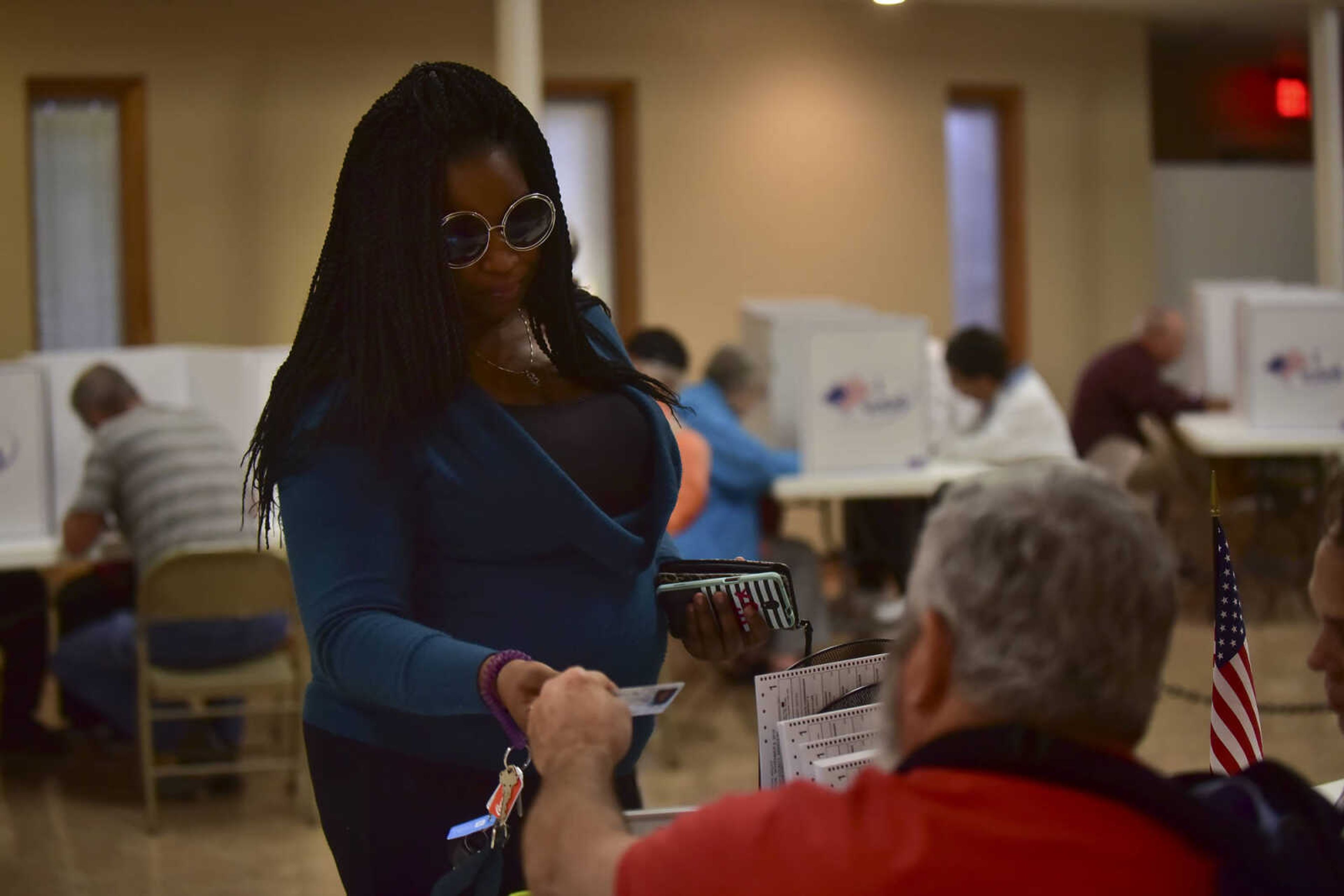 ANDREW J. WHITAKER ~ awhitaker@semissourian.com
Ambria Webb, left, hands over her photo identification at St. Andrew Lutheran Church Tuesday, Nov. 8, 2016 in Cape Girardeau.