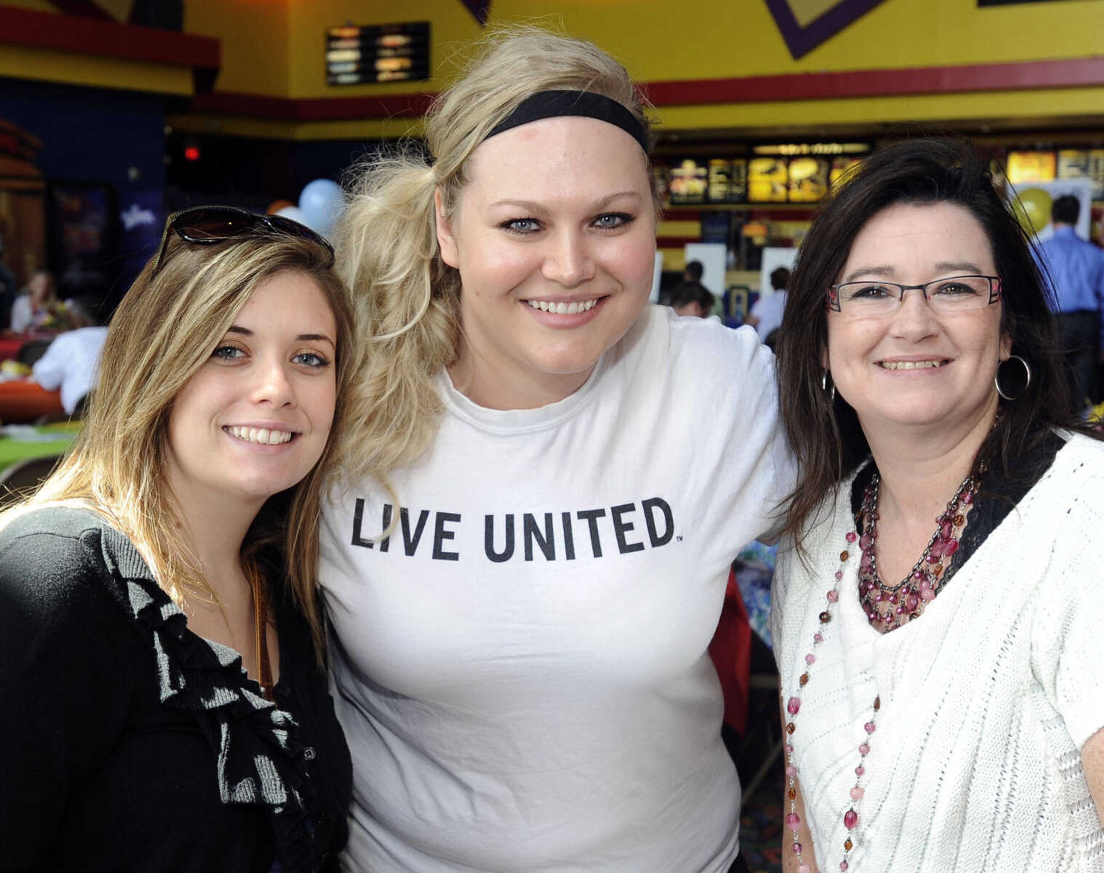 Katie Ammon, left, Erica Wheeler and Dana Hukel pose at the United Way of Southeast Missouri campaign kickoff Aug. 30 at West Park 14 Cine.