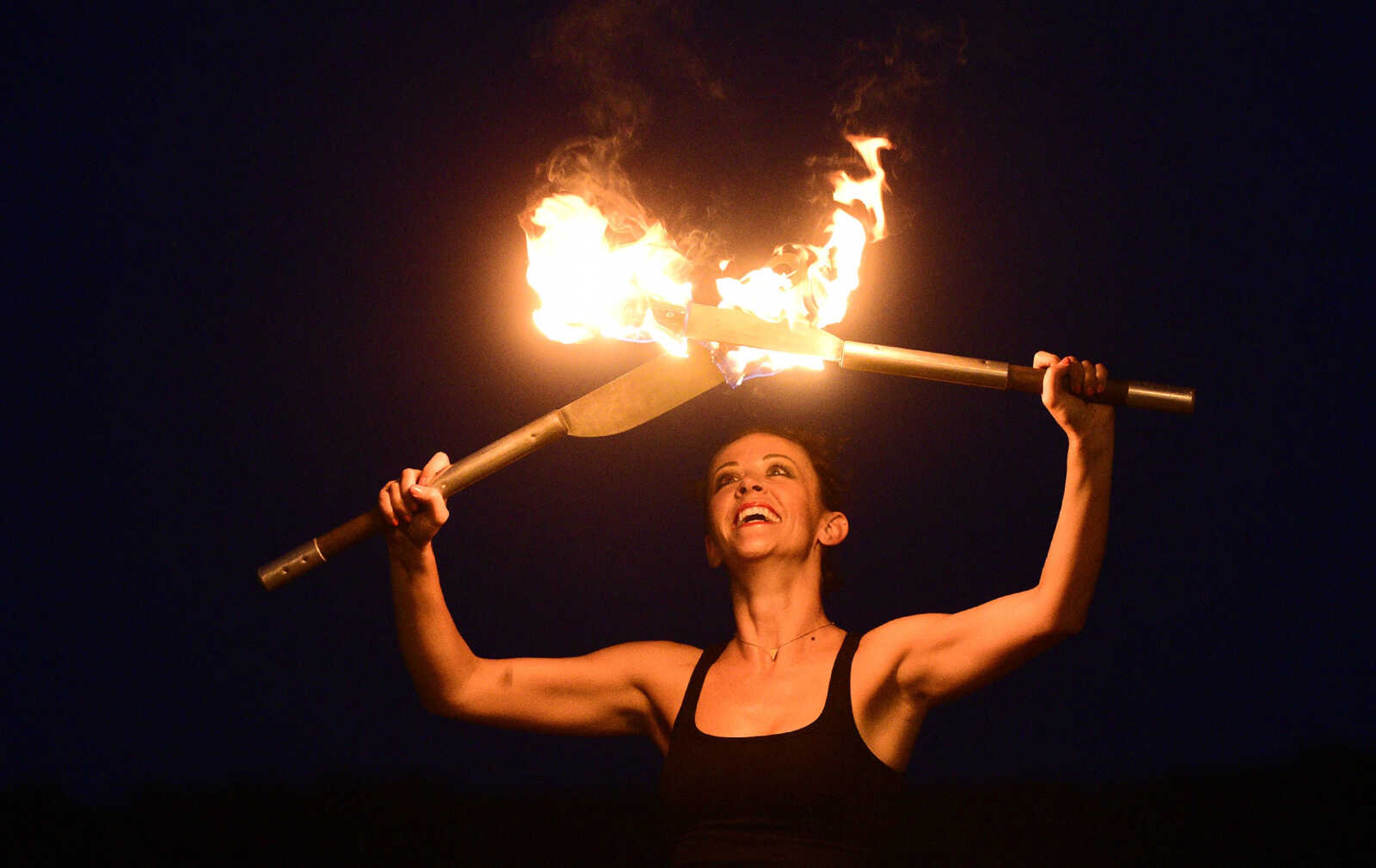 Erin Fluegge twirls flaming knives along the riverfront on Friday, June 16, 2017, in downtown Cape Girardeau.