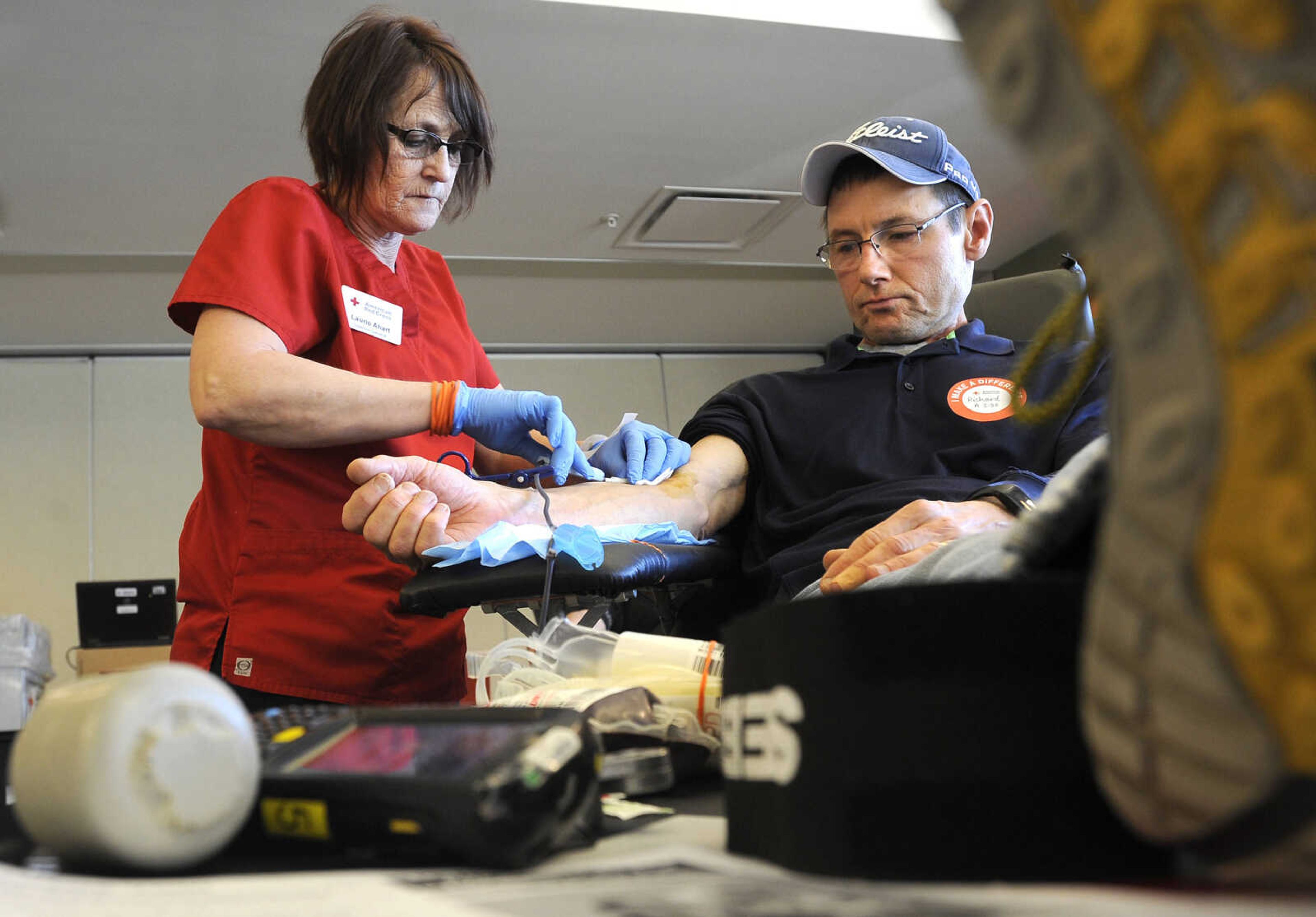 FRED LYNCH ~ flynch@semissourian.com
Laurie Ahart of the American Red Cross assists Rick Lott with a blood donation Thursday, Jan. 25, 2018 at the Cape Girardeau Public Library. The Red Cross is on emergency appeal for blood and platelets, according to Red Cross account manager Michelle Johnson. "More blood is going out than is coming in," she said. "The weather and the flu have negatively impacted the blood supply. Only 3 percent of the population donate blood, and the average donor gives twice a year."