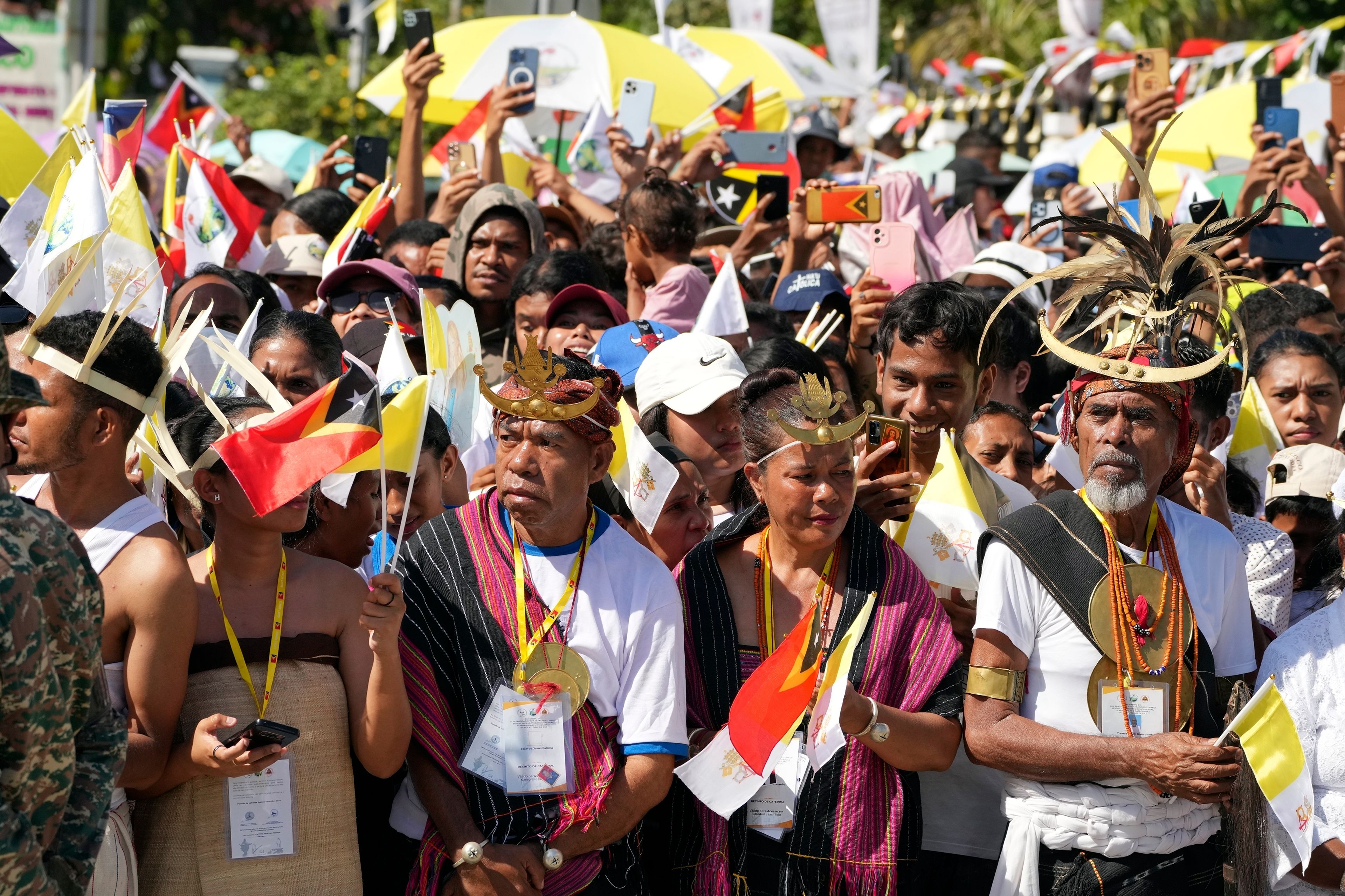 People wait for Pope Francis to arrive at the Cathedral of the Immaculate Conception in Dili, East Timor, Tuesday, Sept. 10, 2024. (AP Photo/Firdia Lisnawati)