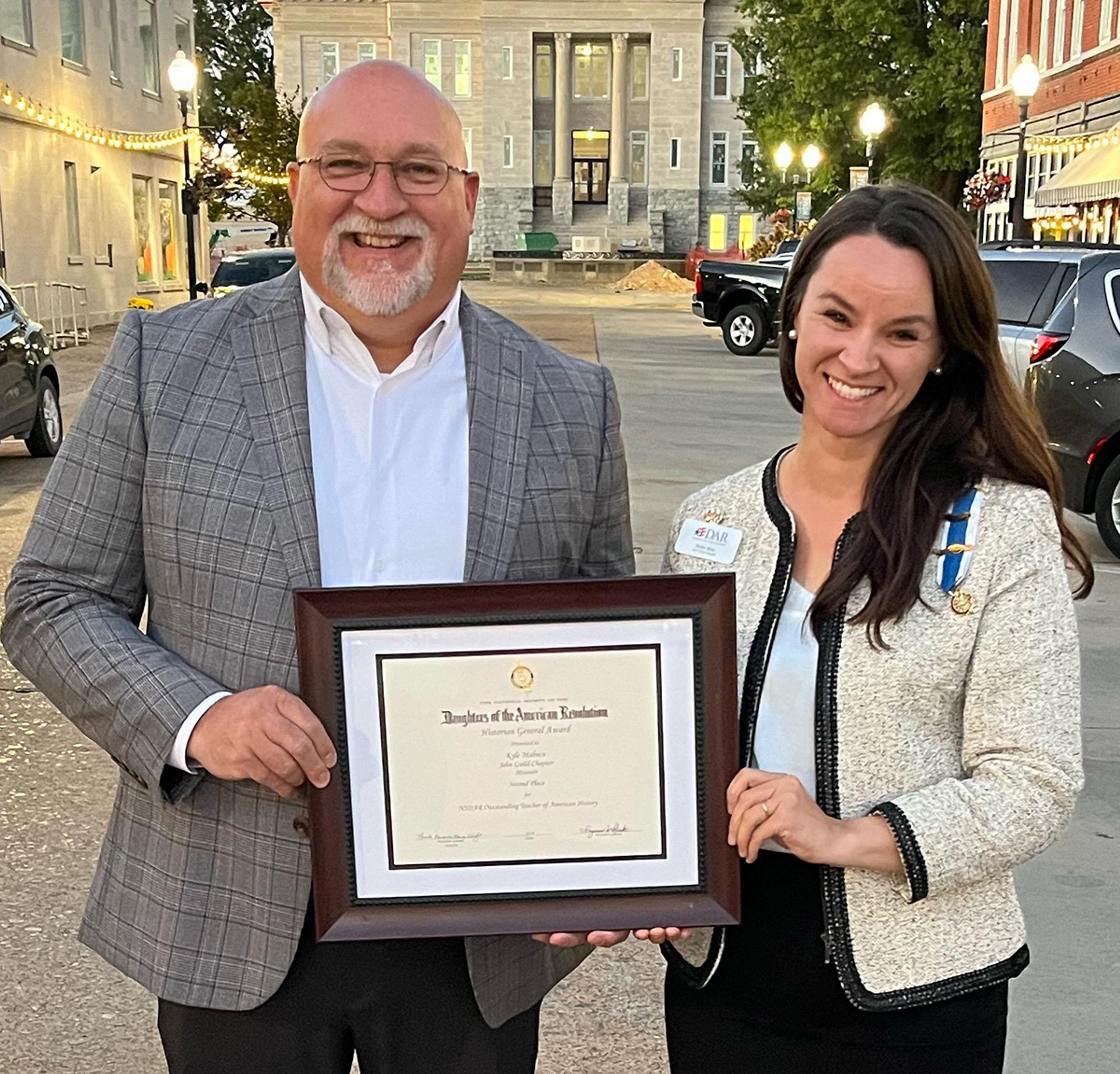 National Society Daughters of the American Revolution second-place winner for
Outstanding Teacher of American History Kyle Mabuce and John Guild Chapter Vice Regent Robin Blair.