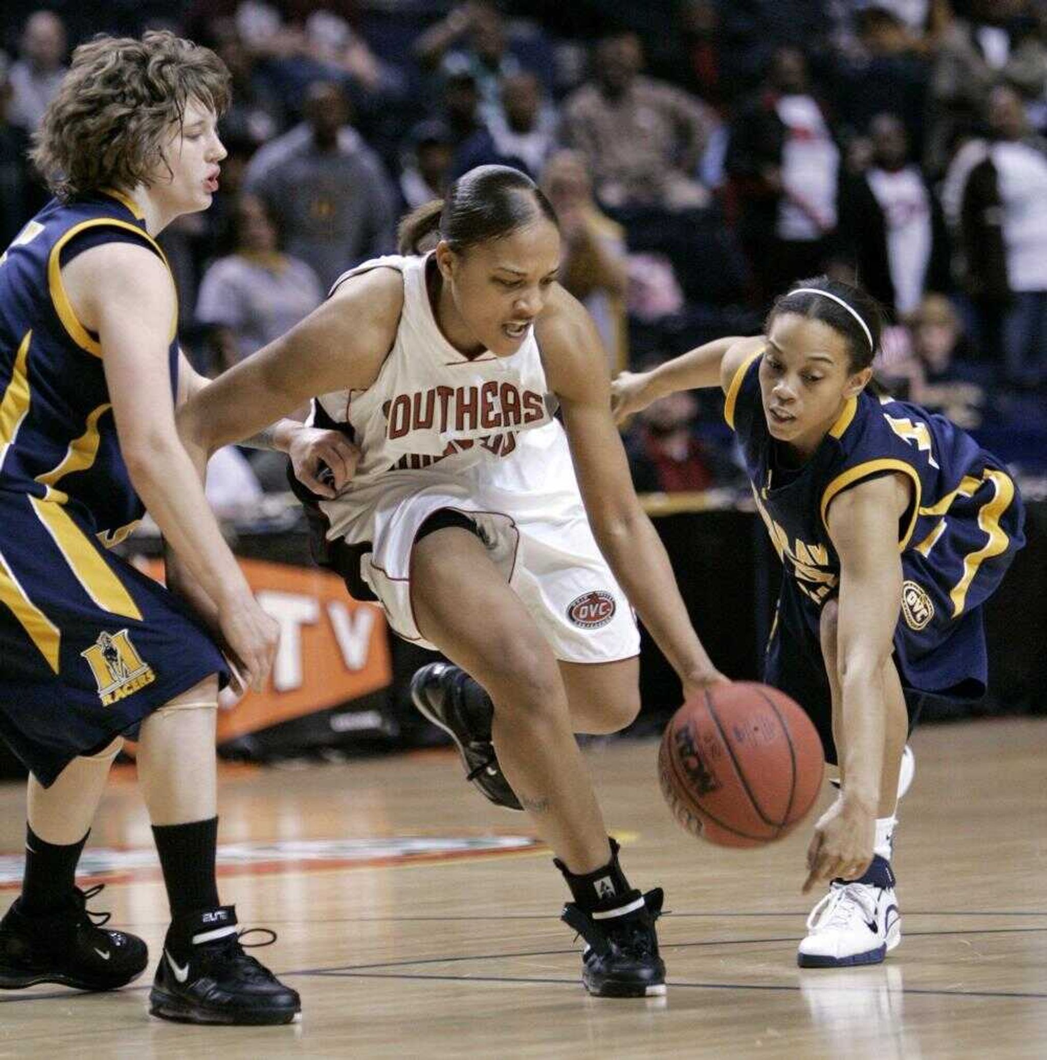 Southeast Missouri State guard Sonya Daugherty, center, dribbled through Murray State's Amber Guffey, left, and Shaleea Petty, right, in the second half of the championship game at the Ohio Valley Conference tournament in Nashville, Tenn. (MARK HUMPHREY ~ Associated Press)