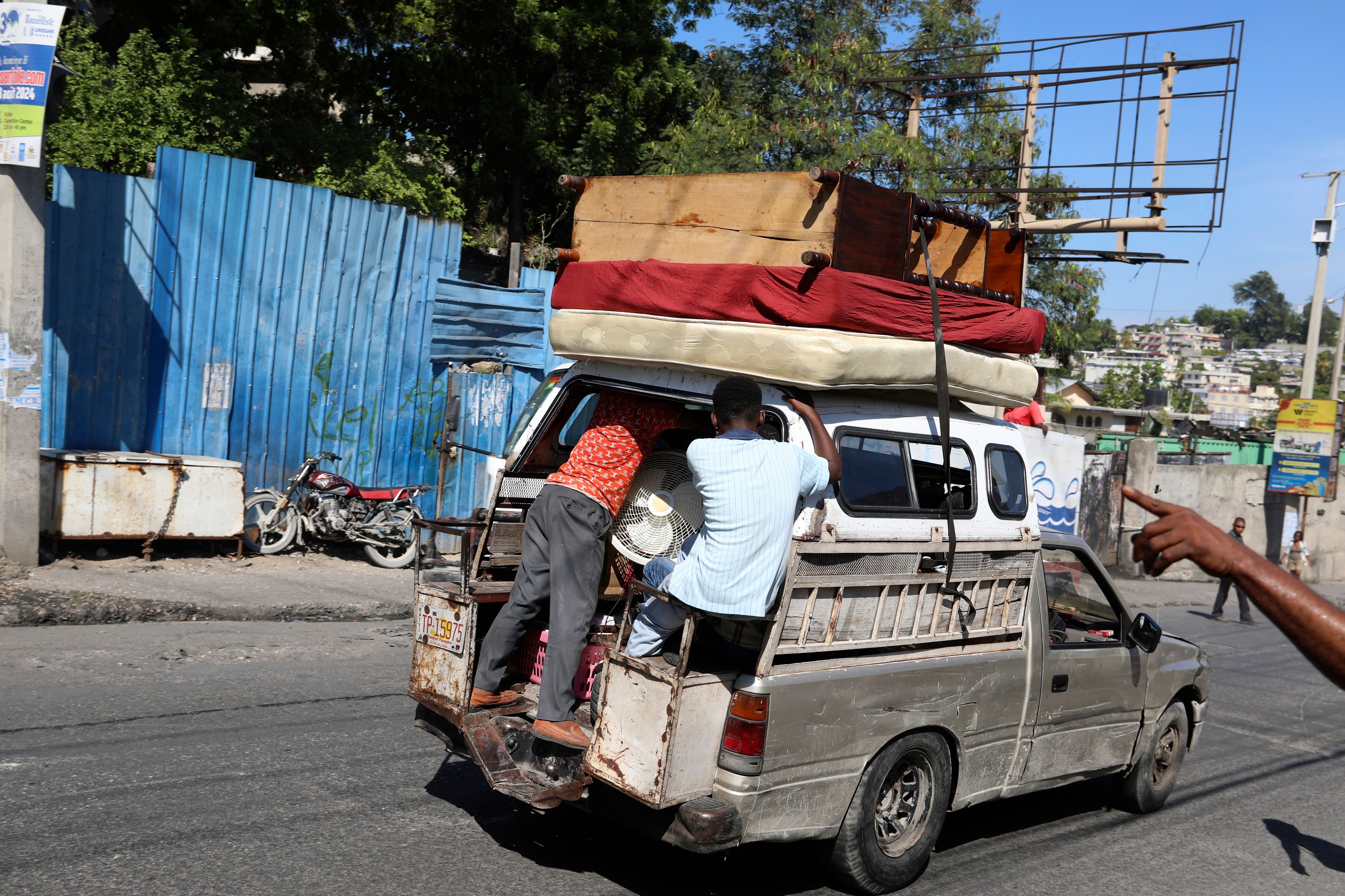 Residents flee their home escaping gang violence in the Solino neighborhood of Port-au-Prince, Haiti, Saturday, Oct. 26, 2024. (AP Photo/Odelyn Joseph)