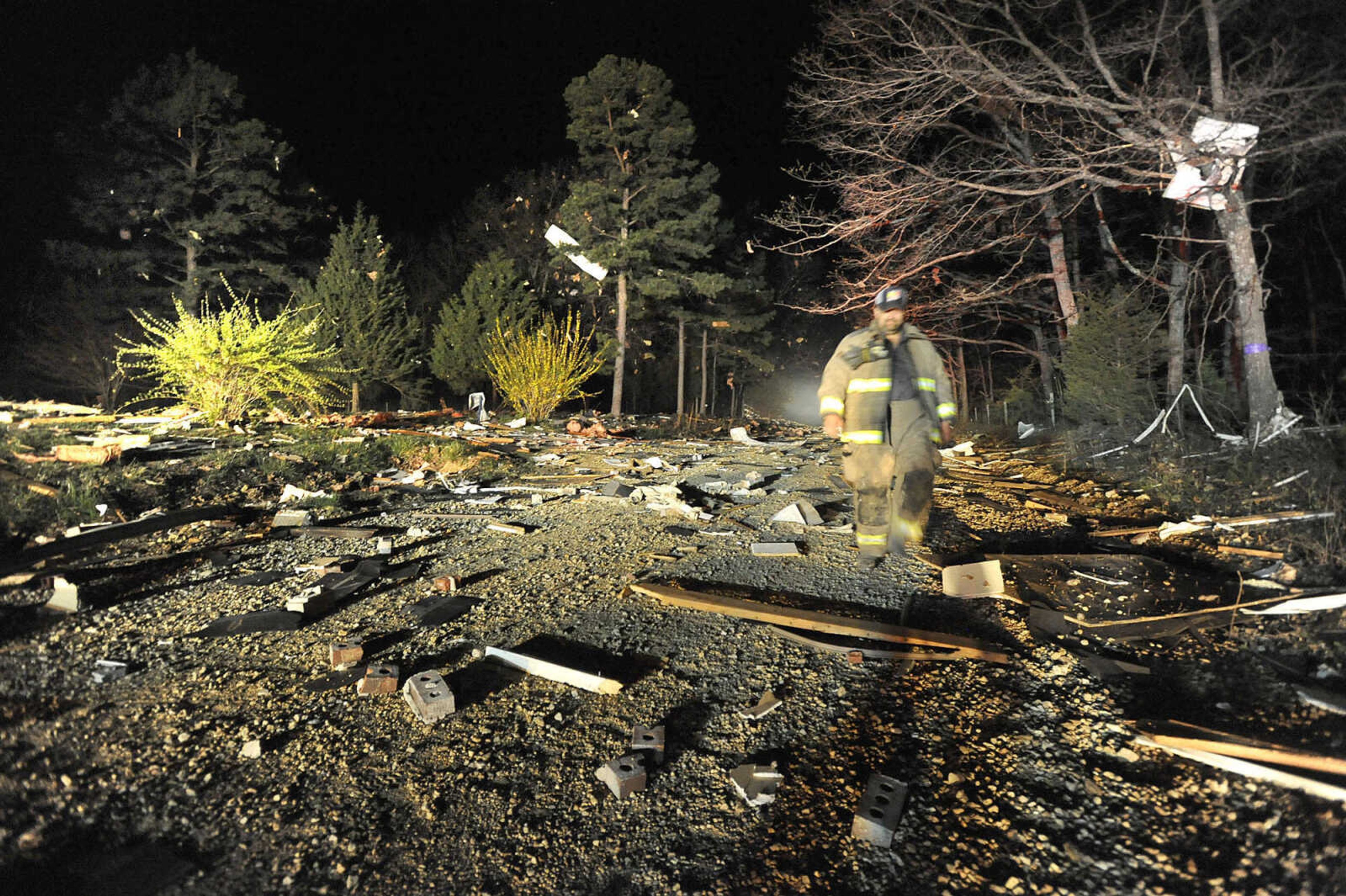 FRED LYNCH ~ flynch@semissourian.com
Debris from a house that exploded off Bollinger County Road 852 covers the road and is caught in trees Saturday night, April 9, 2016 west of Scopus.