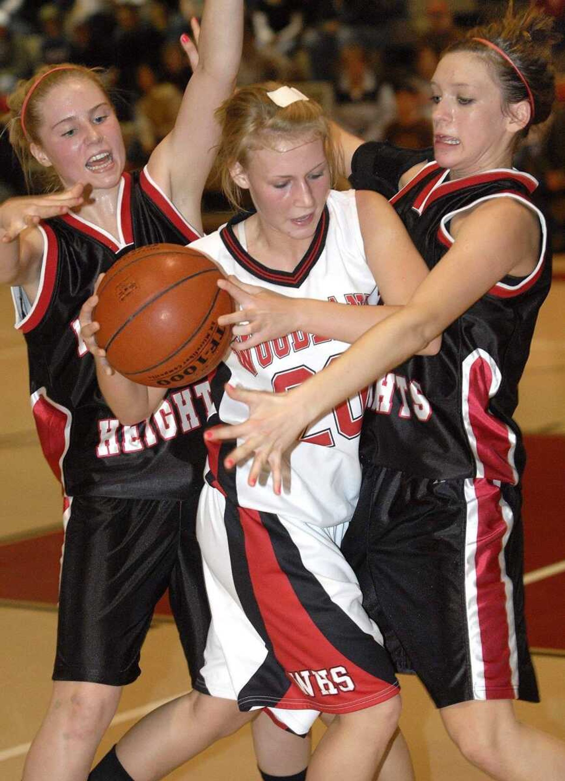 FRED LYNCH ~ flynch@semissourian.comWoodland's Juliet Dickey finds herself caught between Meadow Heights defenders Whitney Welker, left, and Heather Dietiker during the third quarter Thursday at Woodland High School in Marble Hill. Meadow Heights won 62-37. Story on Page 3B. A photo gallery from the game is available at semissourian.com.