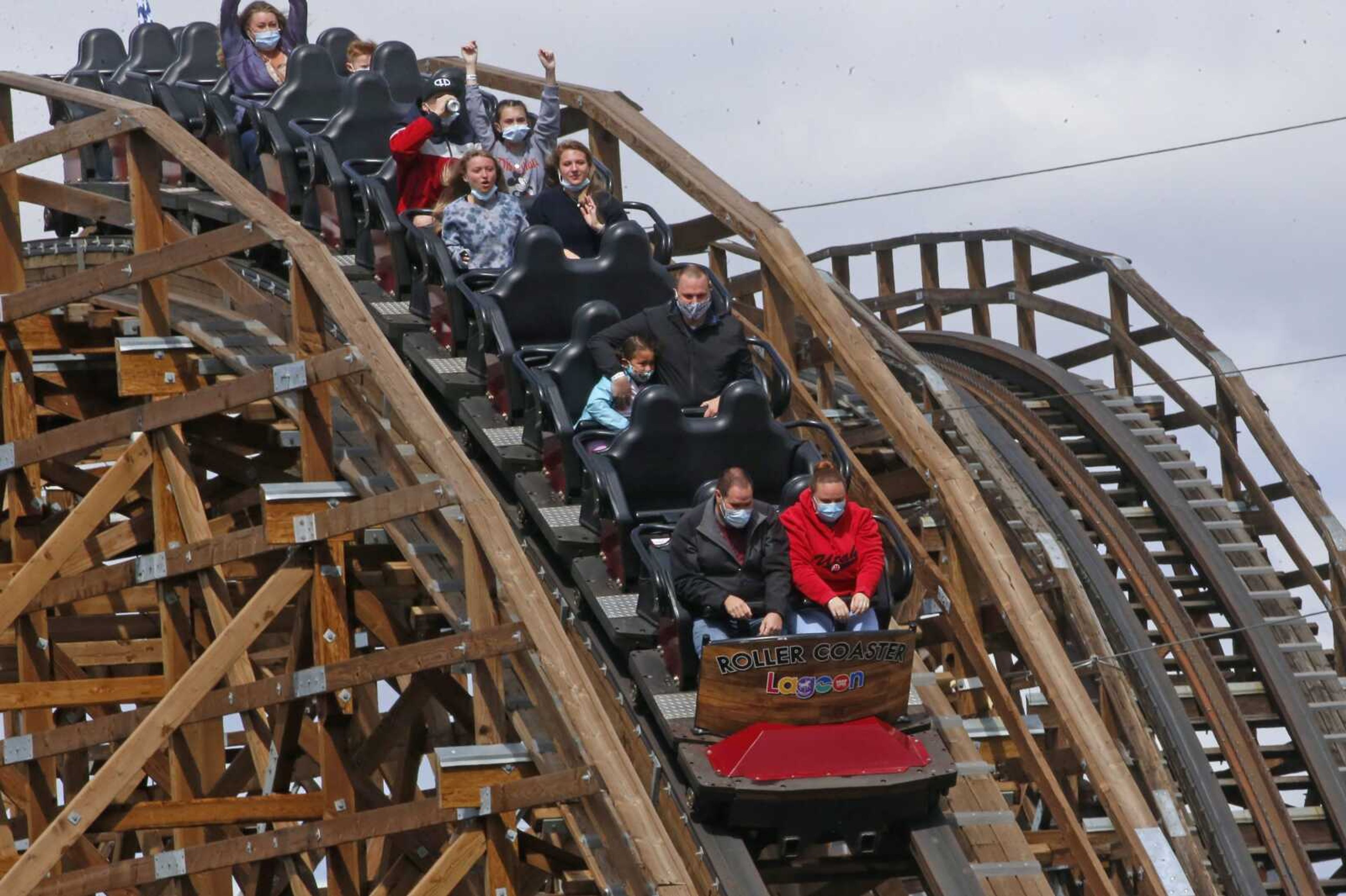 People ride the roller coaster May 23 at Lagoon Amusement Park in Farmington, Utah. After a season break that was extended for months by COVID-19 restrictions, Utah's amusement park, Lagoon, reopened for business just in time for the Memorial Day weekend.