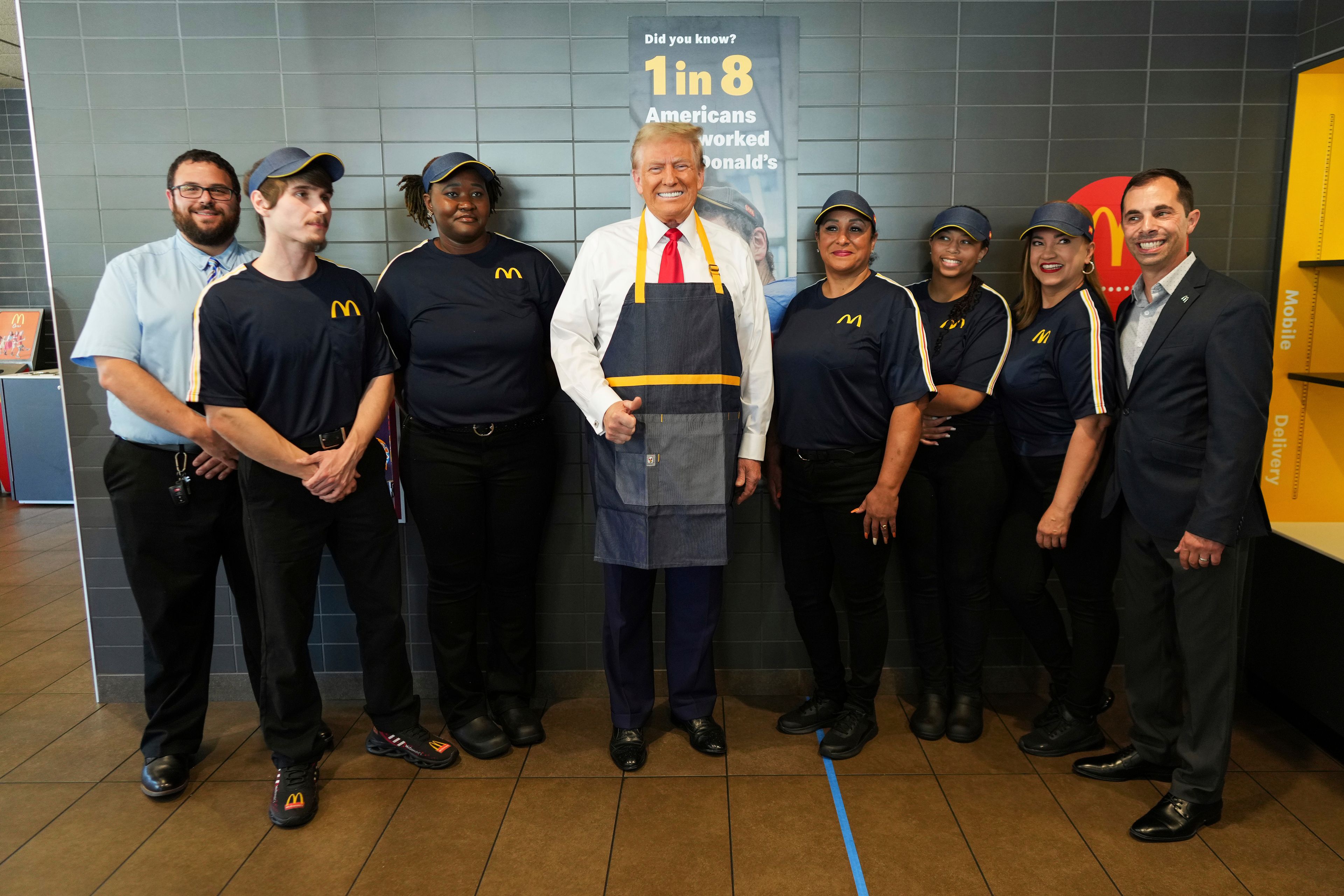 Republican presidential nominee former President Donald Trump poses with employees during a visit to McDonald's in Feasterville-Trevose, Pa., Sunday, Oct. 20, 2024. (Doug Mills/The New York Times via AP, Pool)