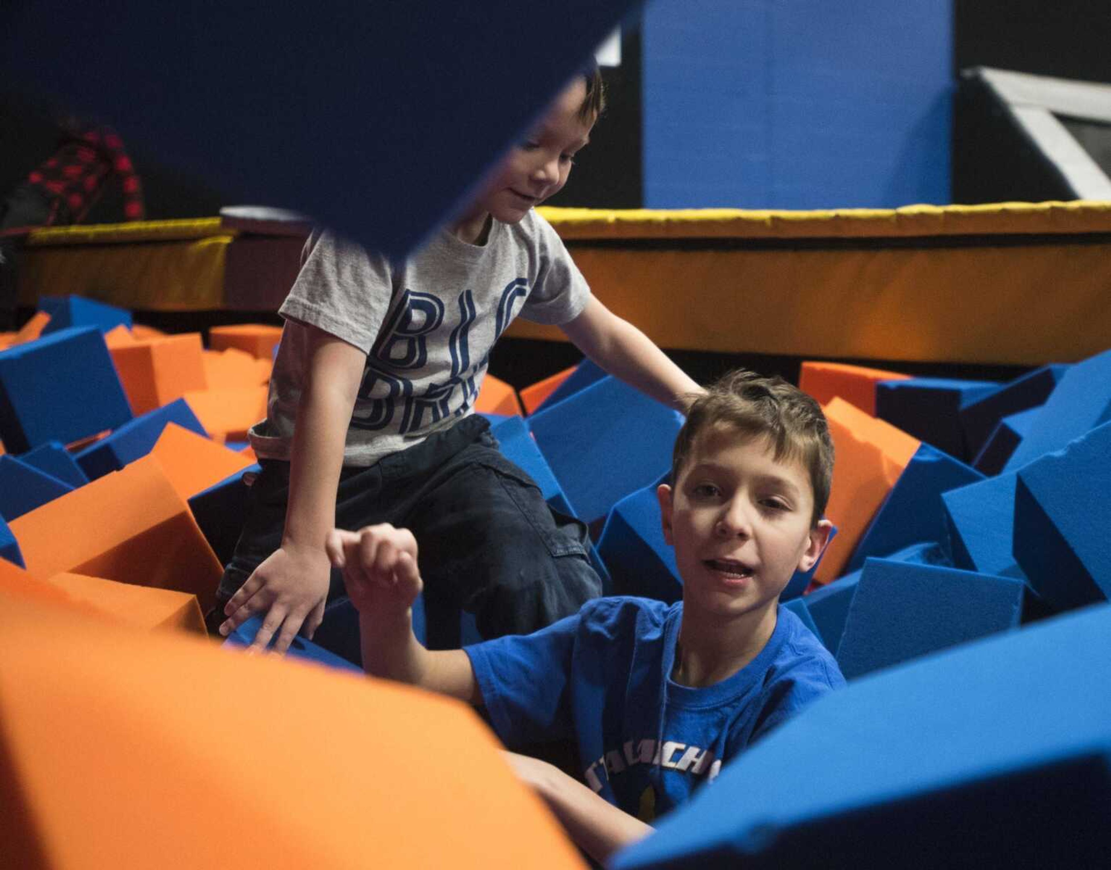 Jackson Mau, 9, below, digs into a pit of foam blocks with his brother, Jordan, 5, during an Easterseals Midwest monthly outing Tuesday, Feb. 13, 2018, at Ultimate Air Trampoline Park in Scott City.