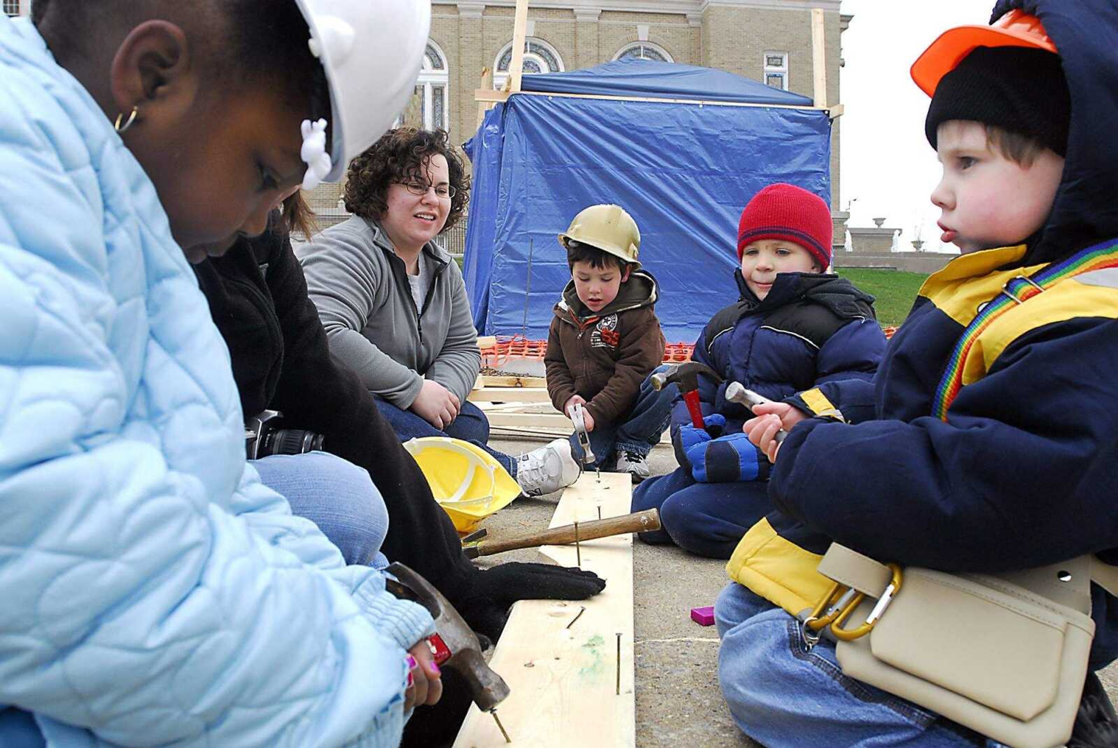 KIT DOYLE ~ kdoyle@semissourian.com
Center for Child Studies preschoolers Allanah Long, left, Jacob Asendorf, Logan Mizicko, and Zach Brazel practice hammering during a field trip to the Habitat for Humanity home being built in the Alumni Center parking lot Thursday, March 12, 2009, in Cape Girardeau.