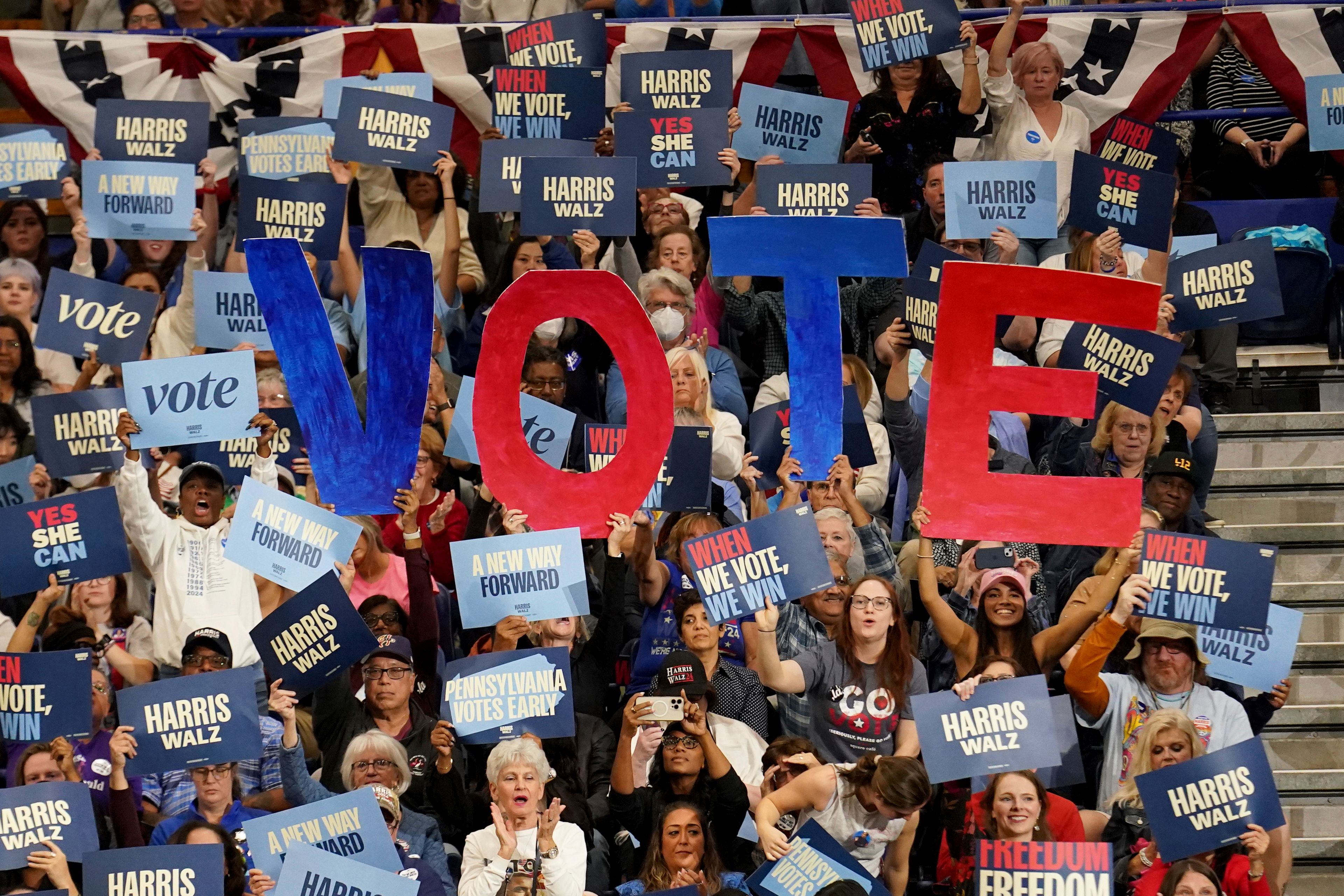 Attendees hold signs as former President Barack Obama speaks during a campaign rally supporting Democratic presidential nominee Vice President Kamala Harris, Thursday, Oct. 10, 2024, at the University of Pittsburgh's Fitzgerald Field House in Pittsburgh. (AP Photo/Matt Freed)