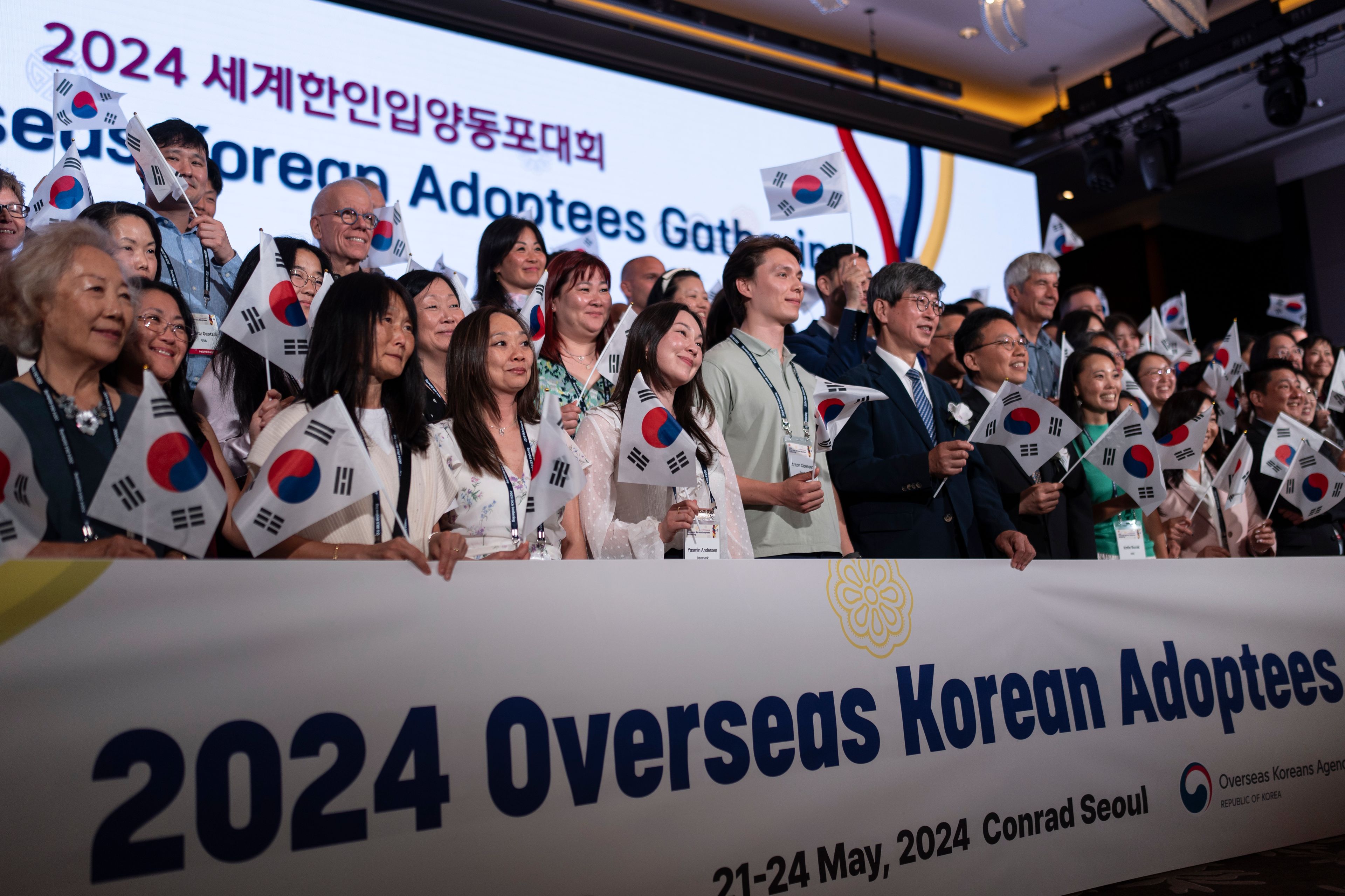 Maja Andersen, front row third from left, an adoptee visiting from Denmark to search for her birth family, holds a South Korean flag with others while taking a group photo at the Overseas Korean Adoptees Gathering in Seoul, South Korea, Tuesday, May 21, 2024. These adoptees are among the 200,000 sent away from Korea to Western nations as children. (AP Photo/Jae C. Hong)