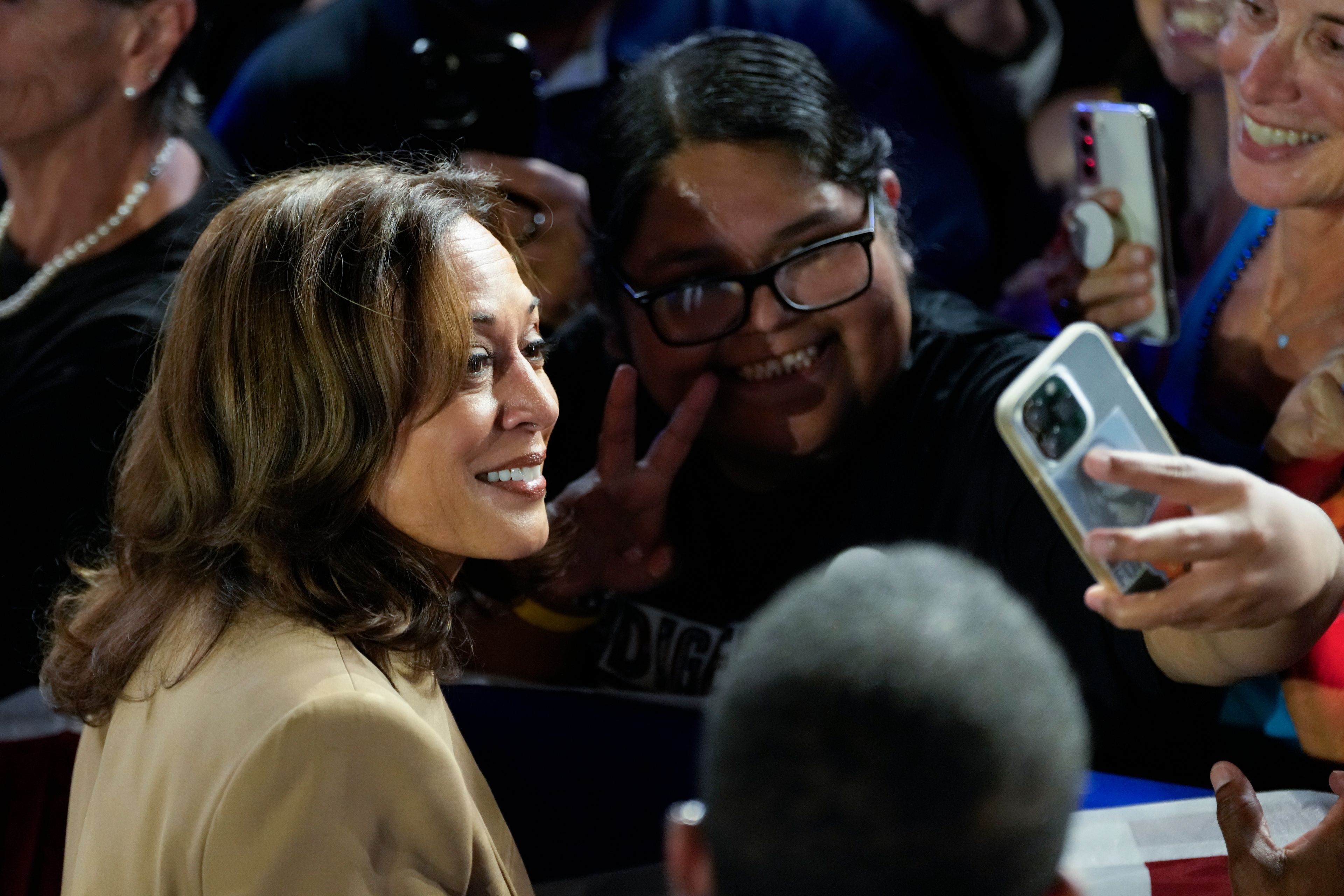 Democratic presidential nominee Vice President Kamala Harris poses for a photo with a supporter after speaking at a campaign event Thursday, Oct. 10, 2024, on the Gila River Indian Community reservation in Chandler, Ariz. (AP Photo/Ross D. Franklin)