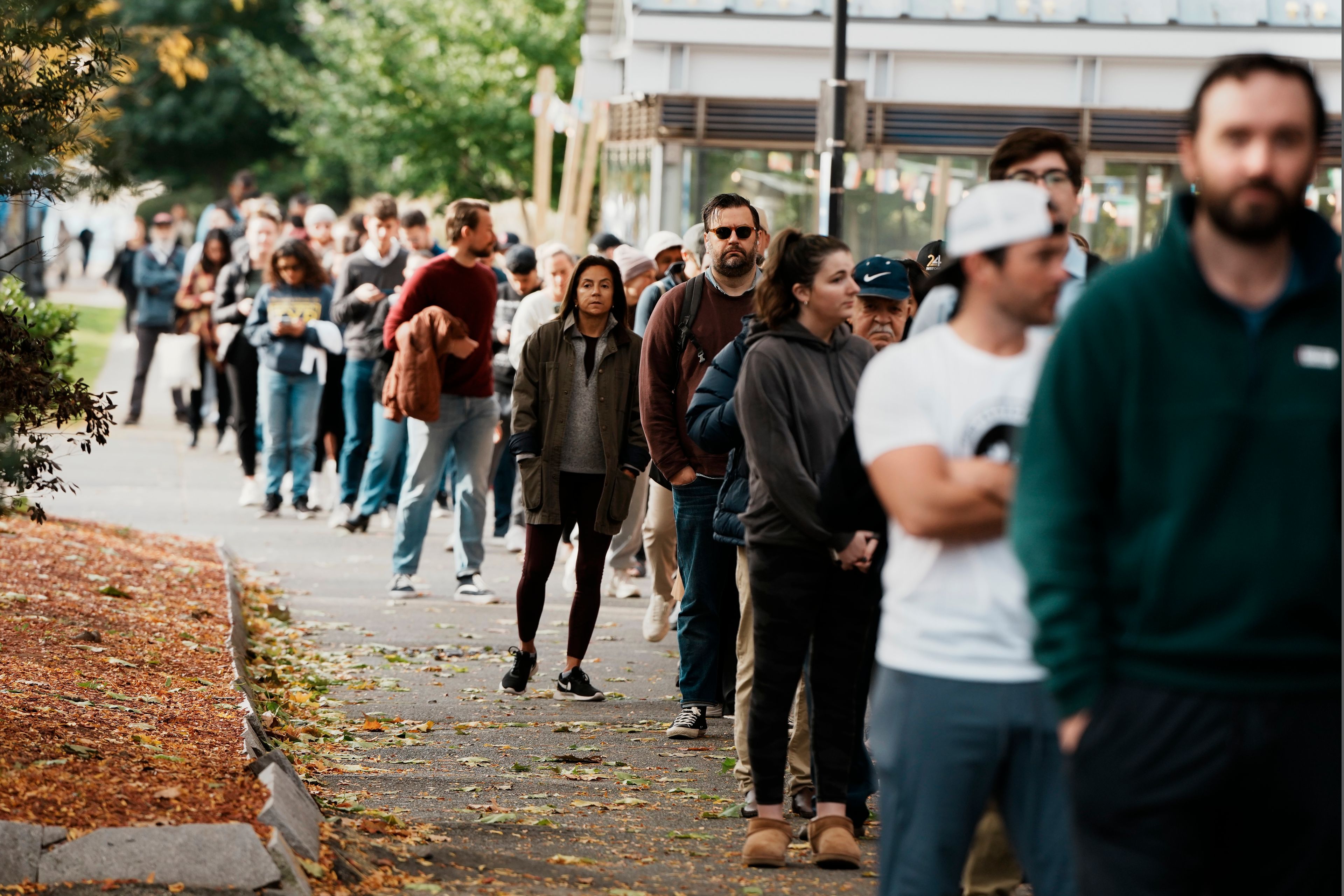 People wait in line to vote on Election Day, Tuesday, Nov. 5, 2024, in the East Boston neighborhood of Boston. (AP Photo/Michael Dwyer)