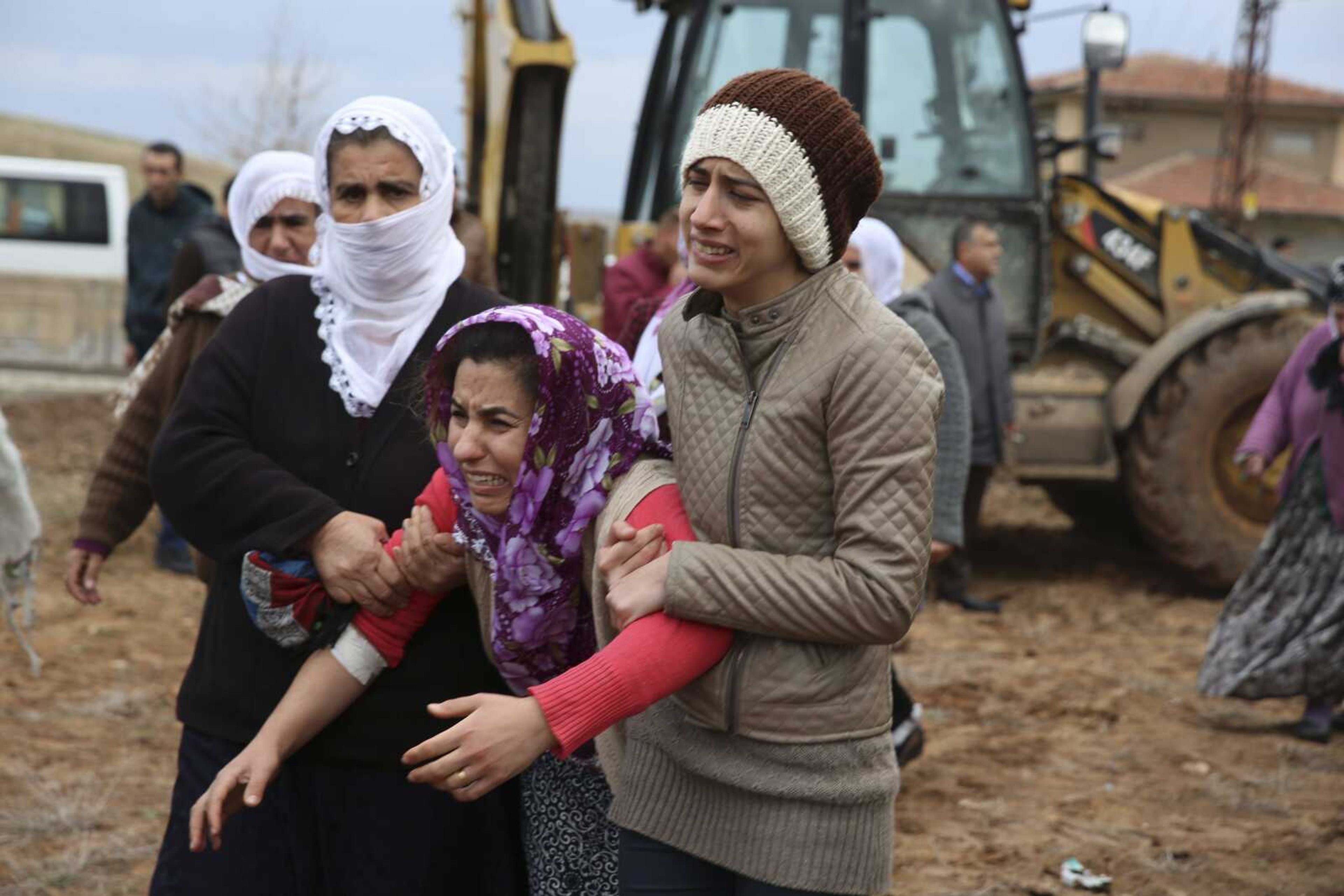 A mourner cries Thursday at the funeral of Lokman Acikgoz and his two sons in Cinar, in the mostly-Kurdish Diyarbakir province in southeastern Turkey. The members of the family were among several people killed late Wednesday when militants detonated a car bomb at a police station in Cinar. (Dominique Sequel ~ Associated Press)