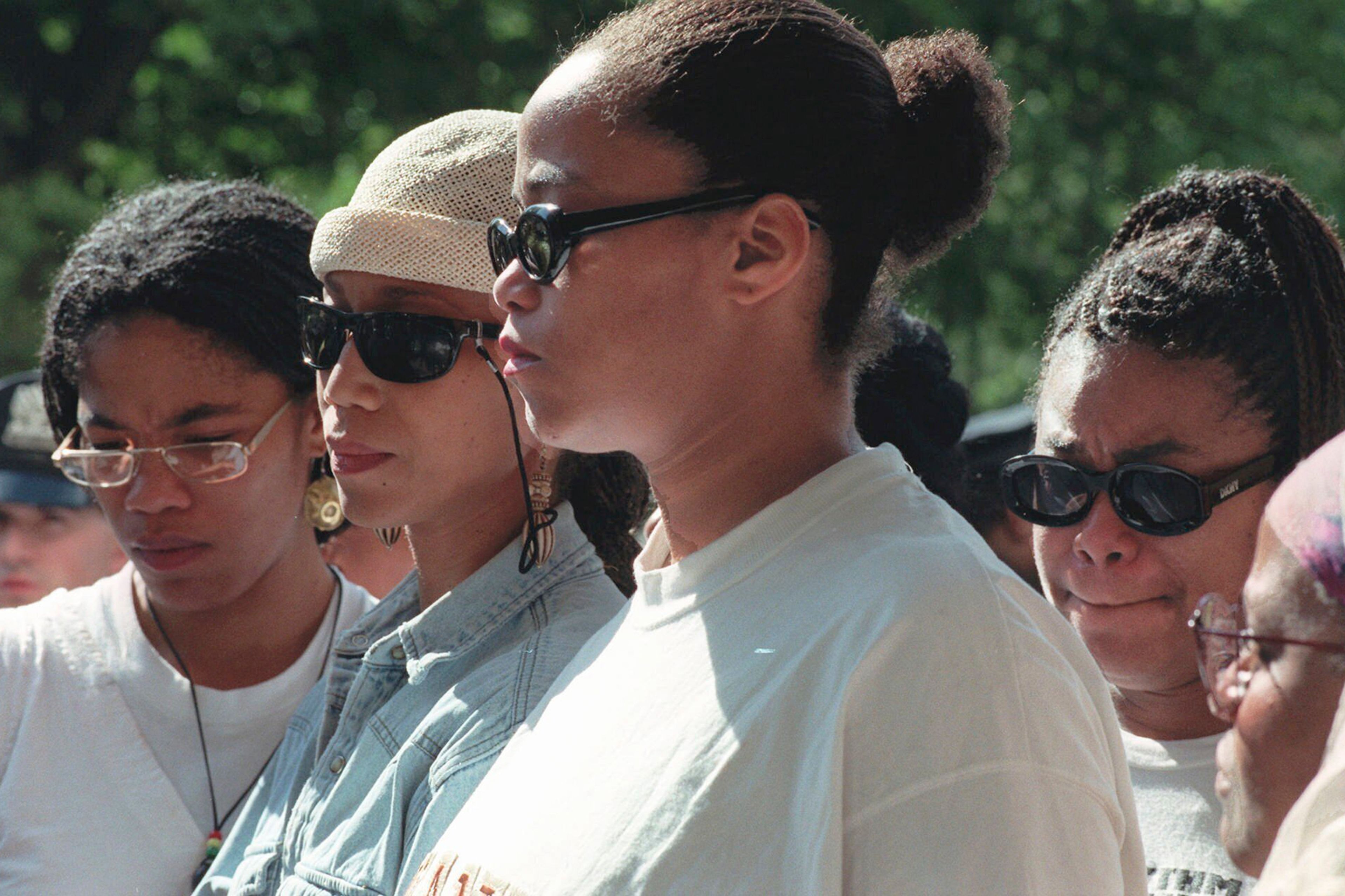 FILE - Malcolm X's daughters Malikah Shabazz, left, Attallah Shabazz, second from left, Malaak Shabazz, third from left, and Gamilah Shabazz, talk to the media outside the Jacobi Medical Center in the Bronx borough of New York, following the death of their mother, Betty Shabazz, June 23, 1997. (AP Photo/Ron Frehm, File)