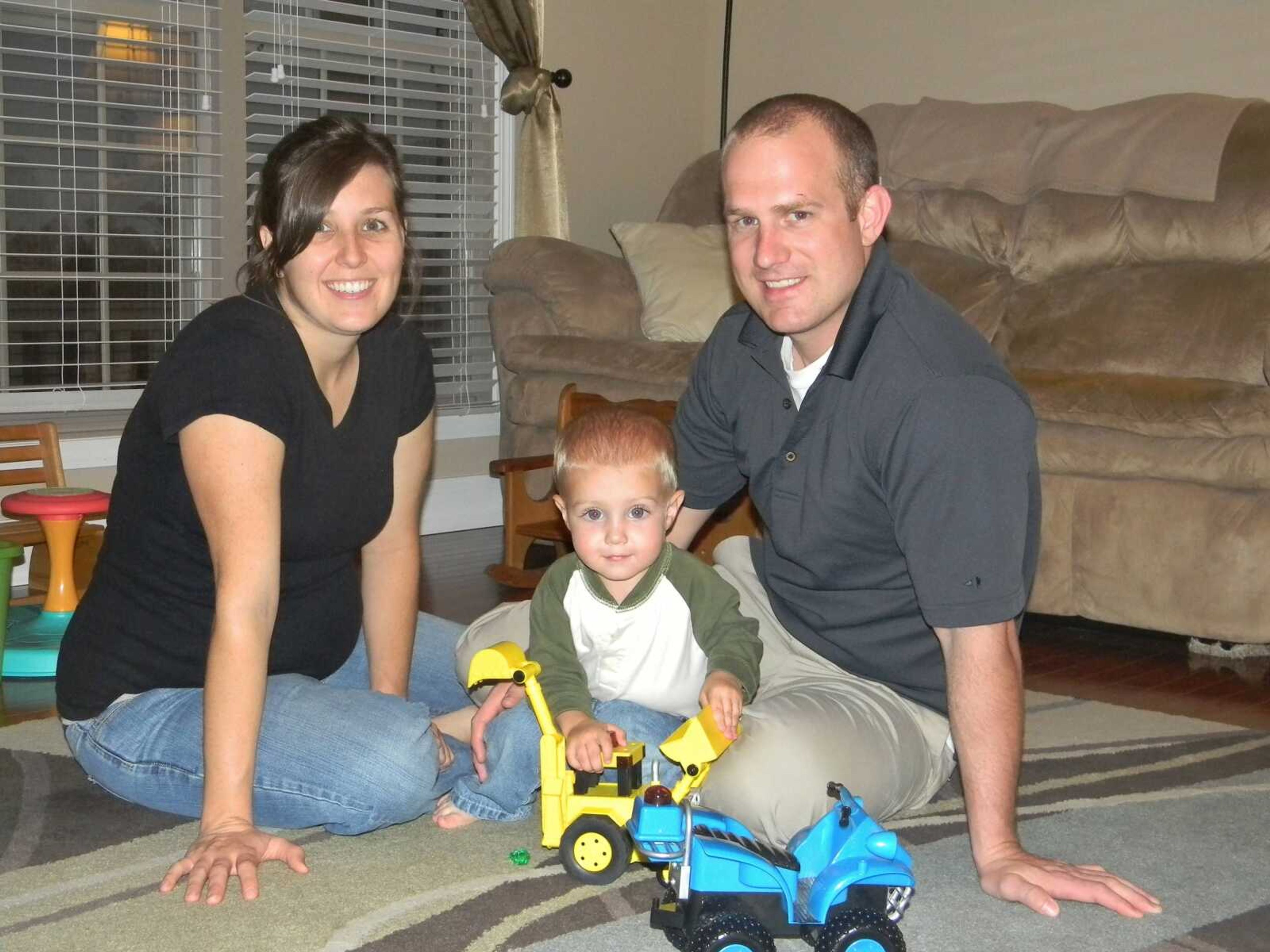 Jenni and Adam Wachter play with their son Wade at their home in Jackson.