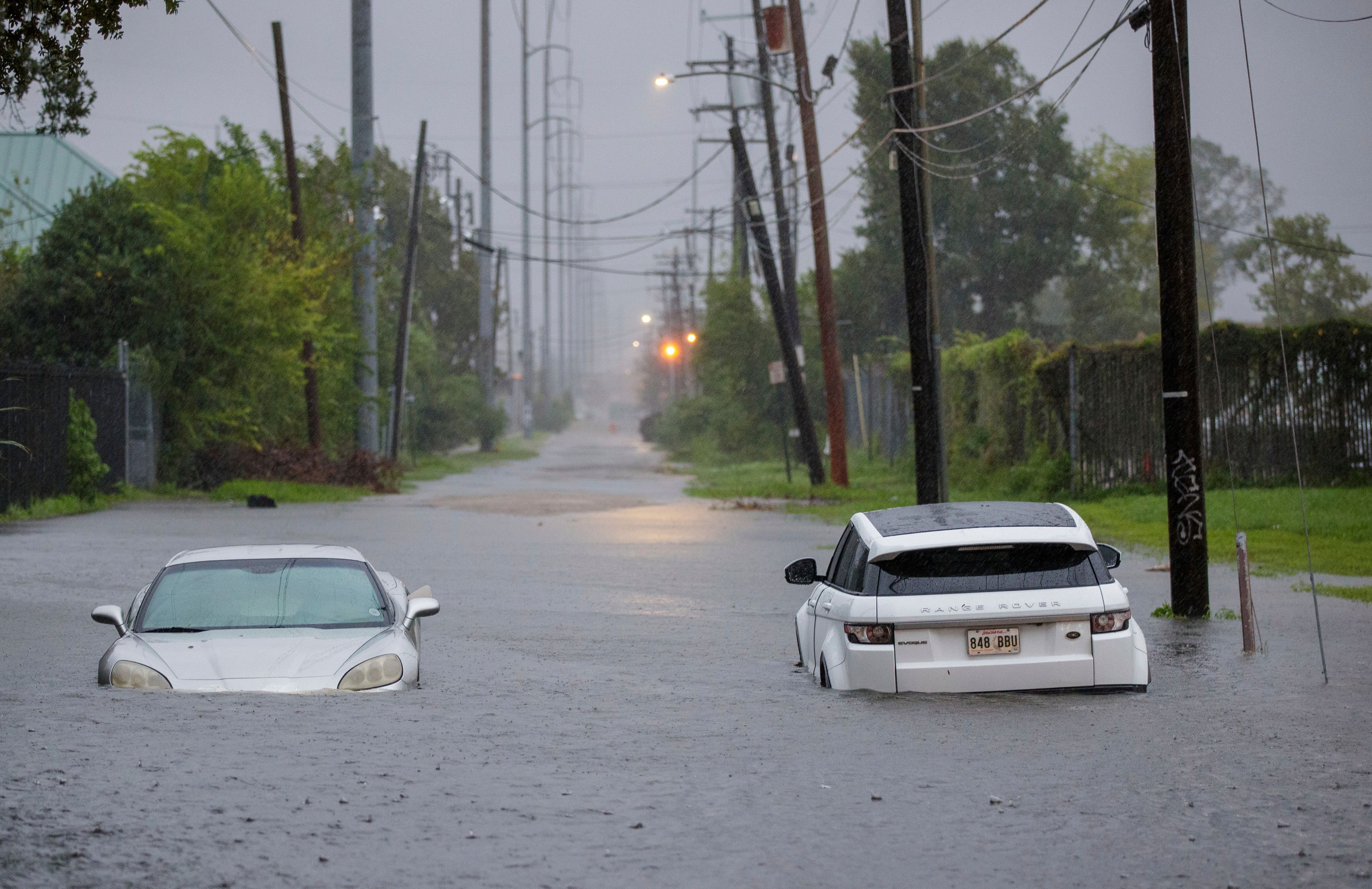 Two vehicle on Olive street are flooded during Hurricane Francine in New Orleans, Wednesday, Sept. 11, 2024. (David Grunfeld/The Times-Picayune via AP)