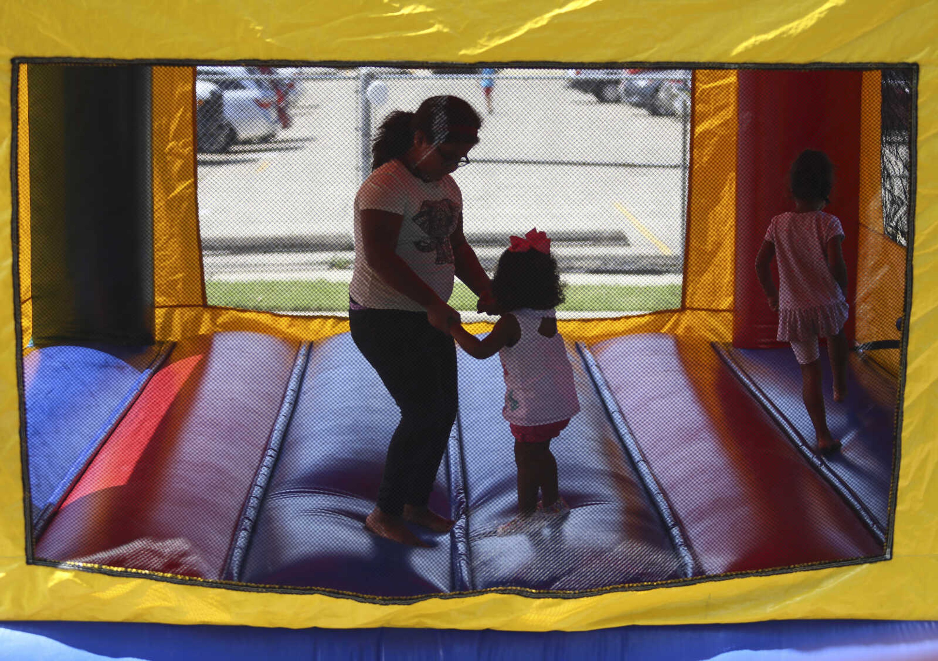 Children play in a bounce house at the St. Mary Cathedral parish picnic on Sunday, August 27, 2017, in Cape Girardeau.