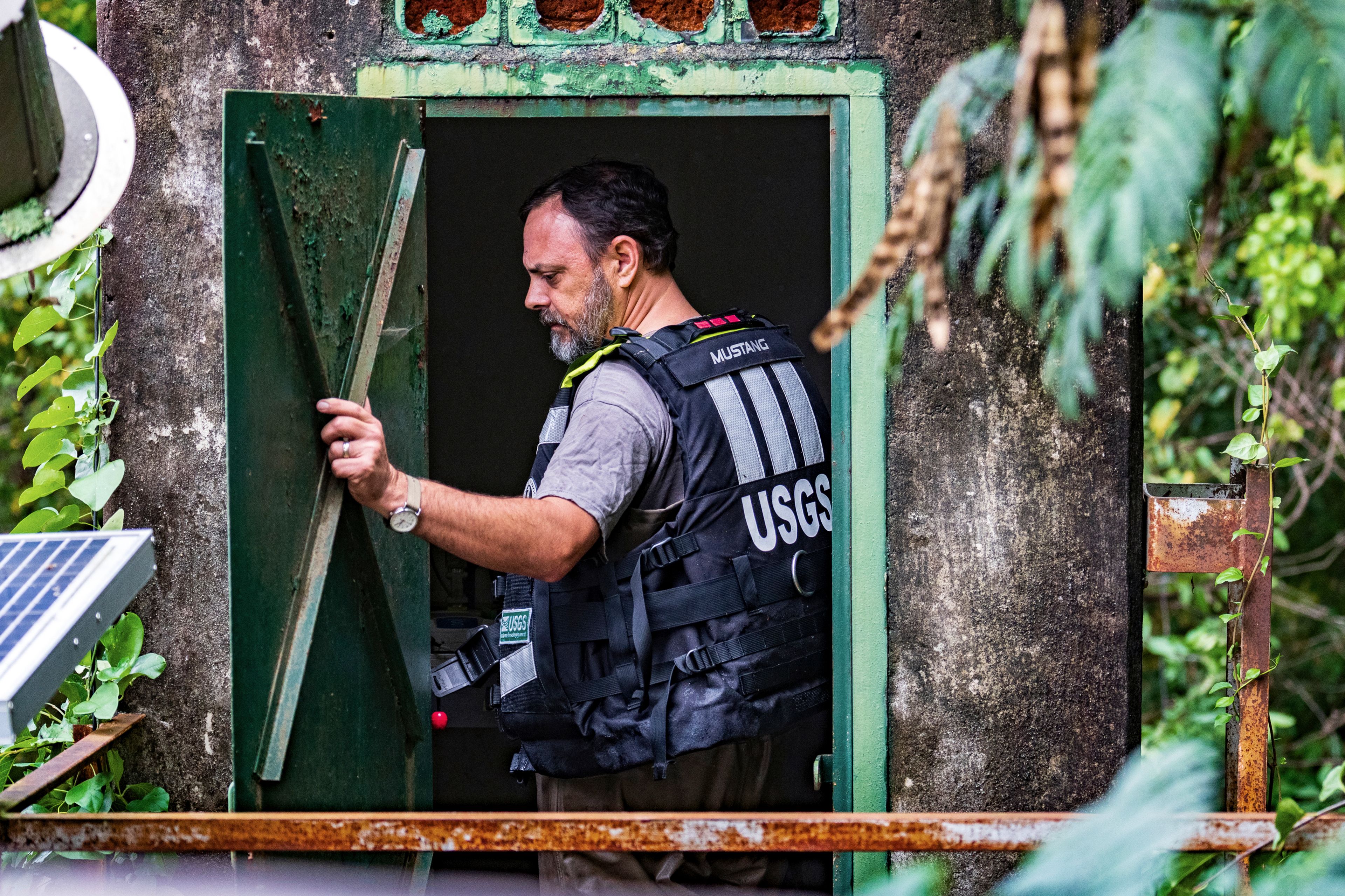 A member of the USGS checks the information in the bridge station on Hermi's Bridge checking the water gauge along the Chattahoochee River near Paces Ferry Drive SE after Hurricane Helene passed the area, Friday, Sept 27, 2024, in Atlanta. (AP Photo/Jason Allen)