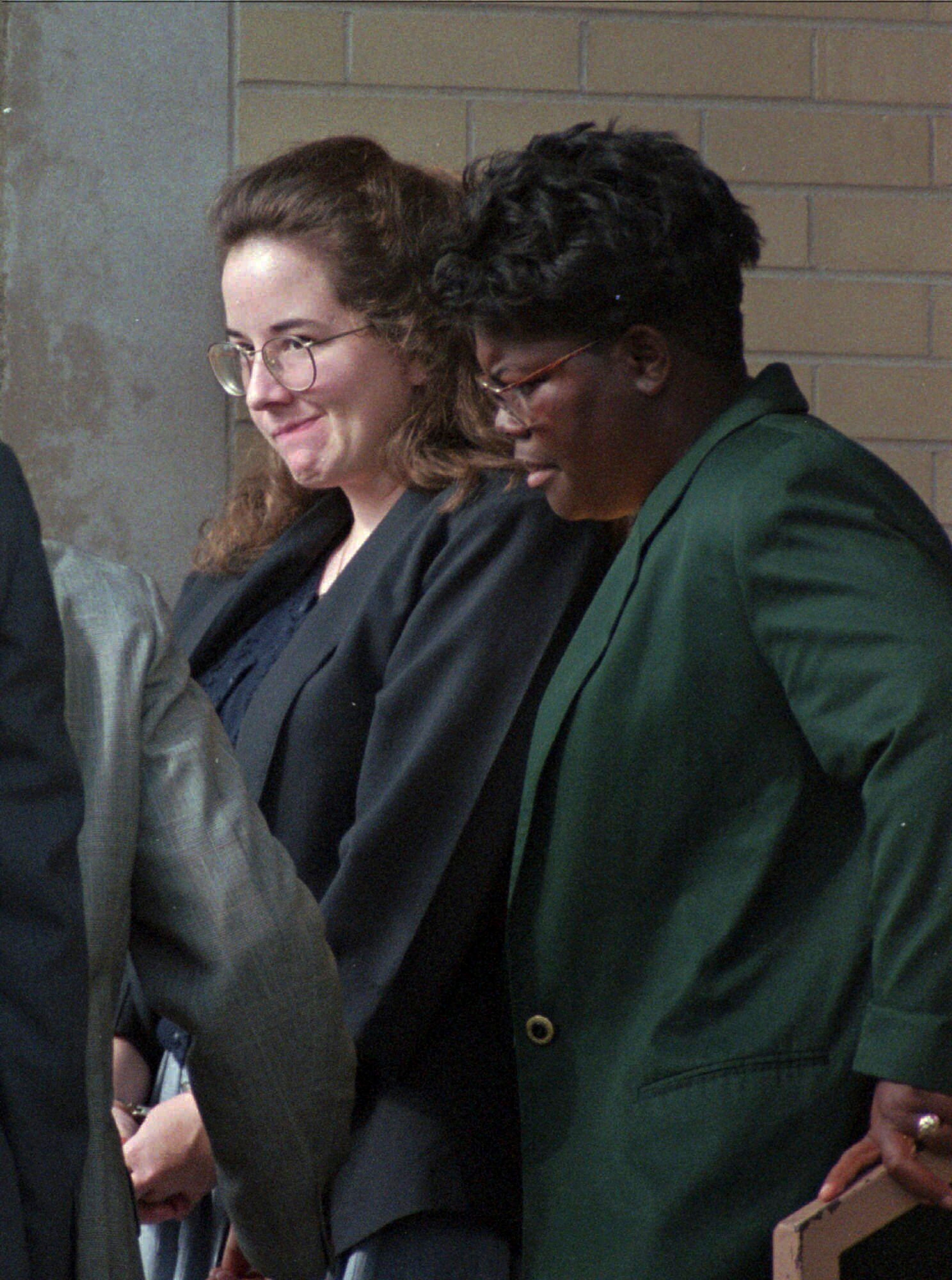 Convicted murderer Susan Smith is escorted from the Union County Courthouse on July 28, 1995 by corrections officer Felicia Mungo after being sentenced to life in prison for the drowning deaths of her two boys last October. (AP Photo/Lou Krasky)