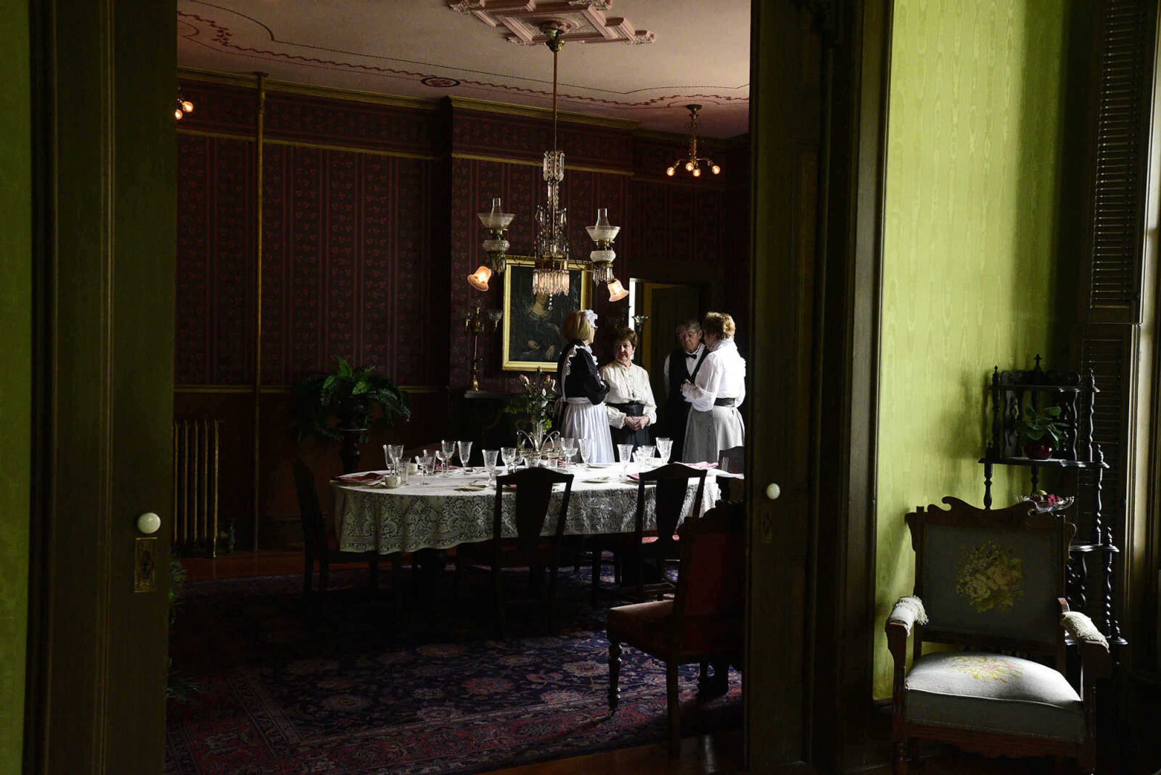 From left to right, Linda Ingram, Mary Lou Bass, Tom Bass and Jane Stephens, all dressed in period costume, visit inside the Glenn House dining room on Wednesday, Aug. 16, 2017, in Cape Girardeau. KMOS-TV, a PBS affiliate, was filming inside the historic home for its Missouri Life show.