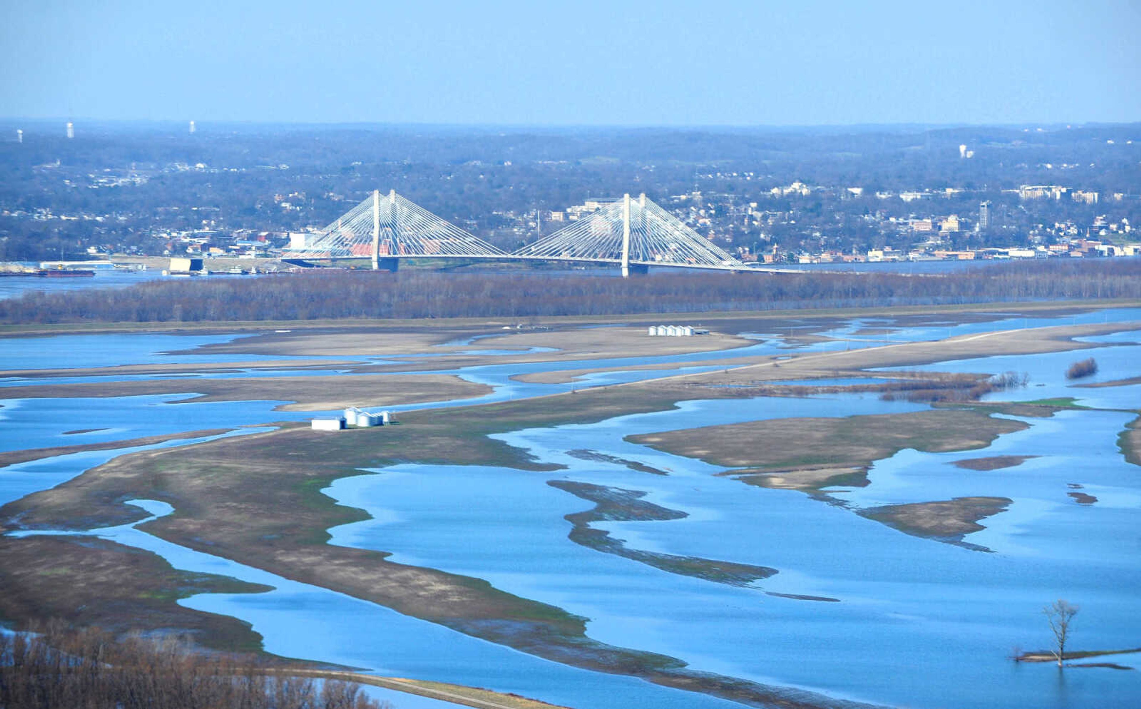 LAURA SIMON ~ lsimon@semissourian.com

The swollen Mississippi River is seen flowing under the Bill Emerson Memorial Bridge in Cape Girardeau, Saturday, Jan. 2, 2016.